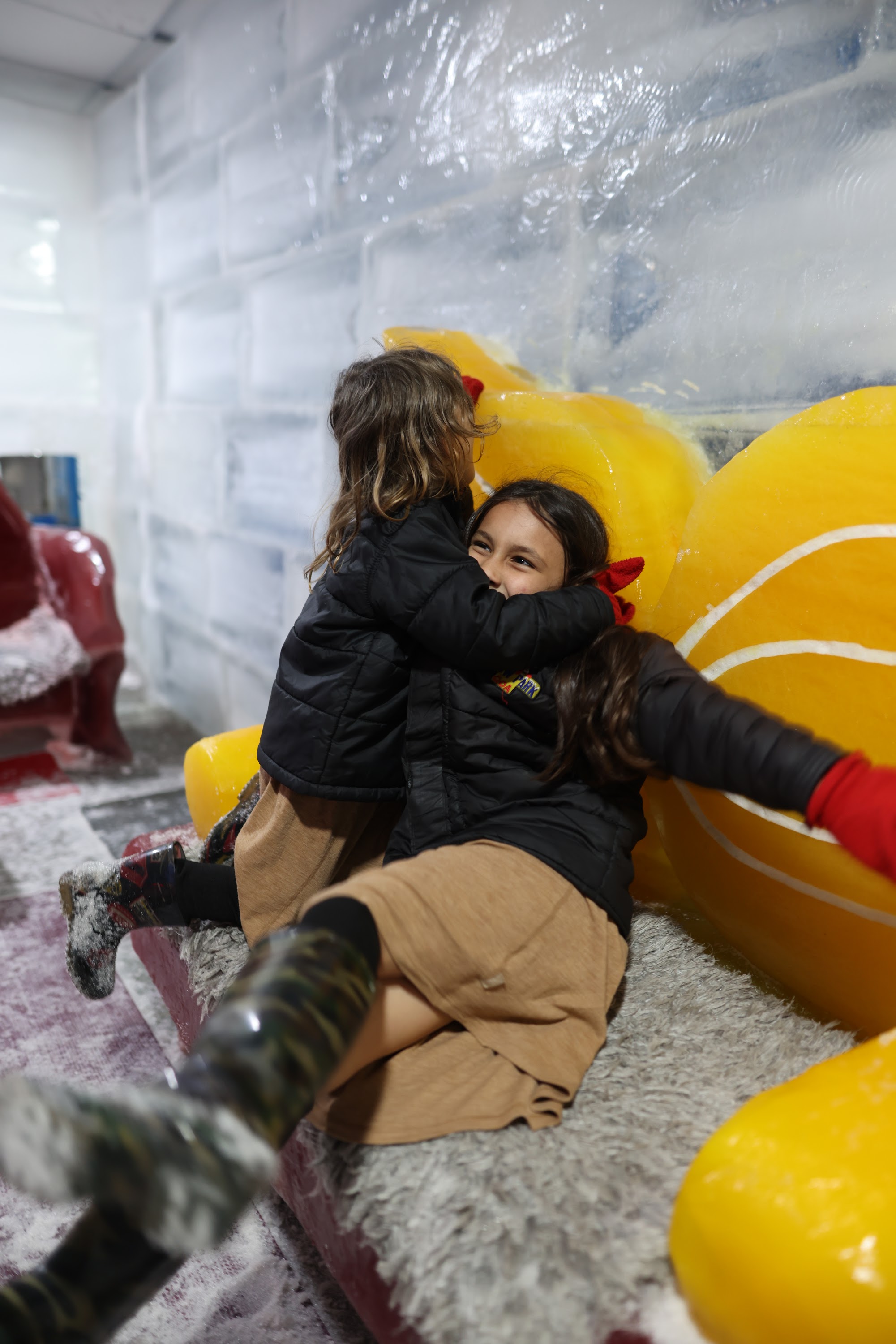 Two Girls Playing on Ice Sculpture