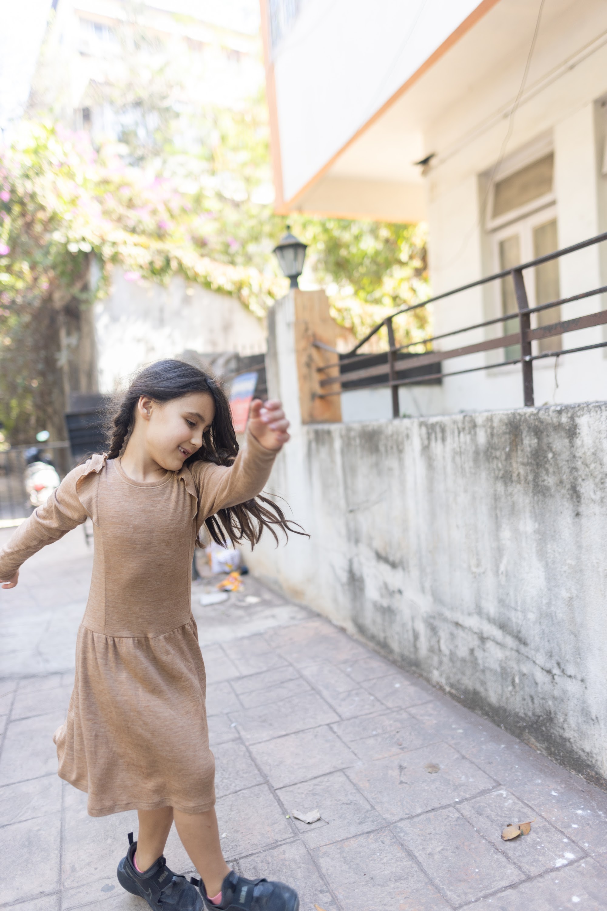 Girl Dancing on a Sunlit Street