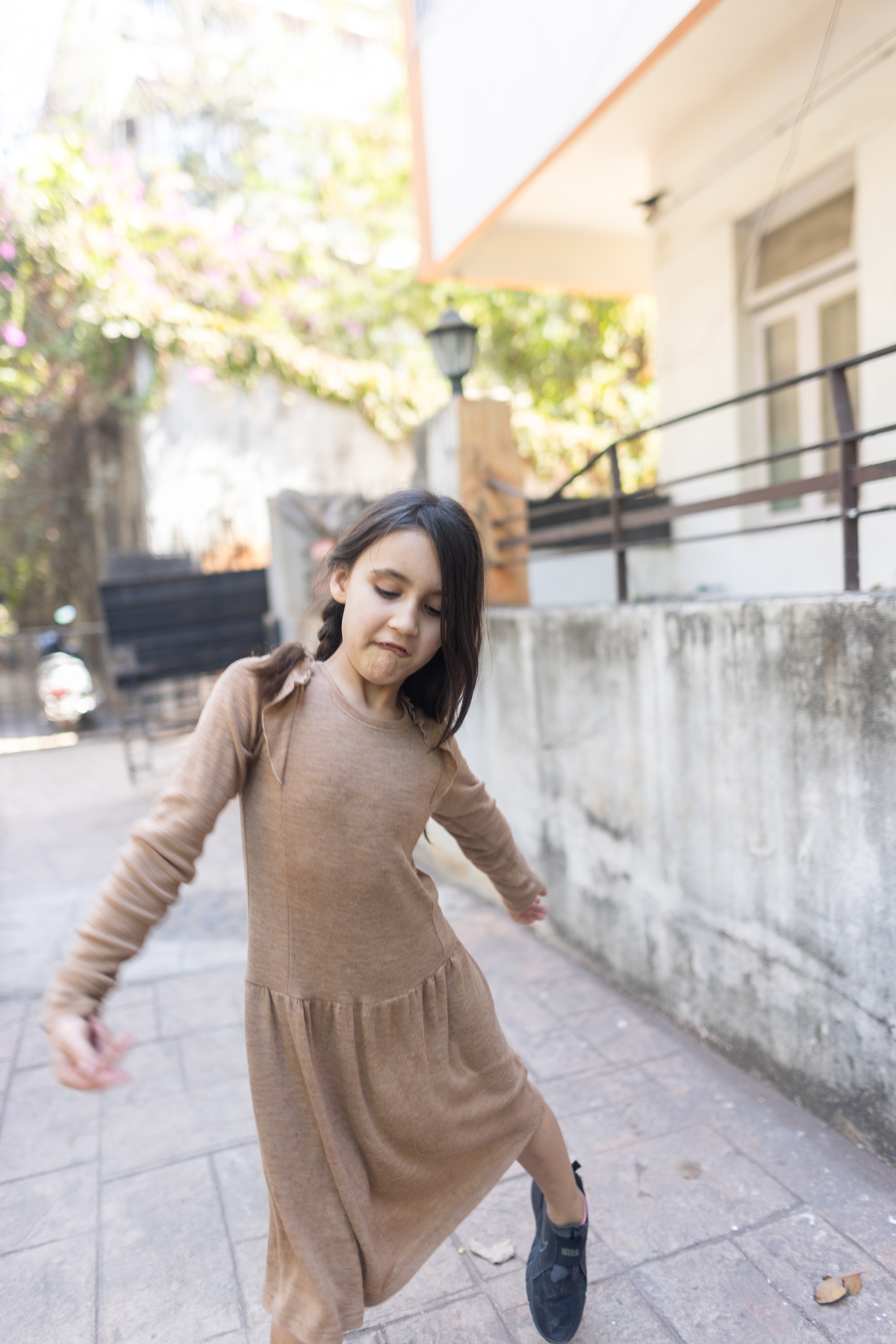 Girl in Brown Dress Dancing Outdoors