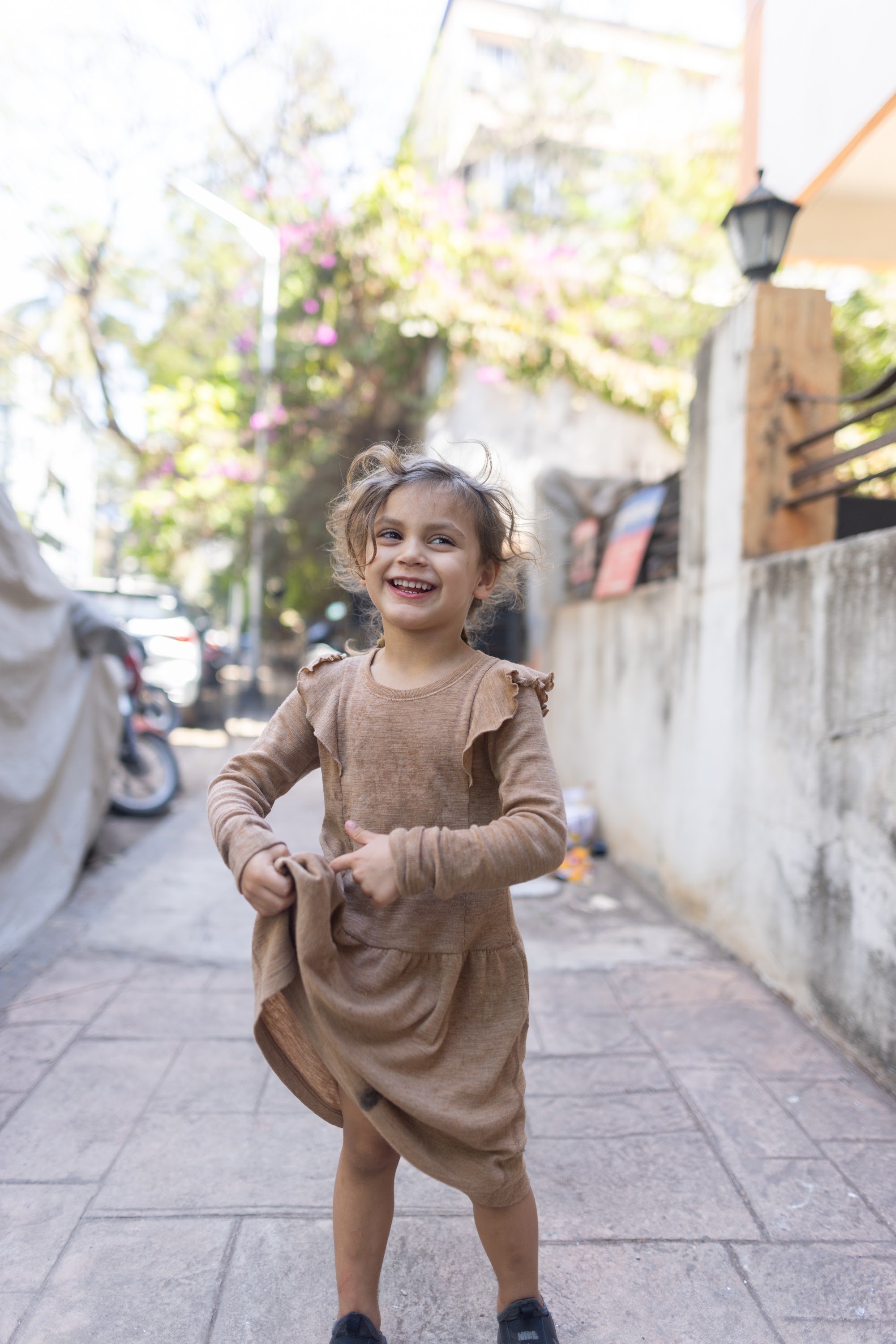 Happy Girl Dancing on a Sunlit Street