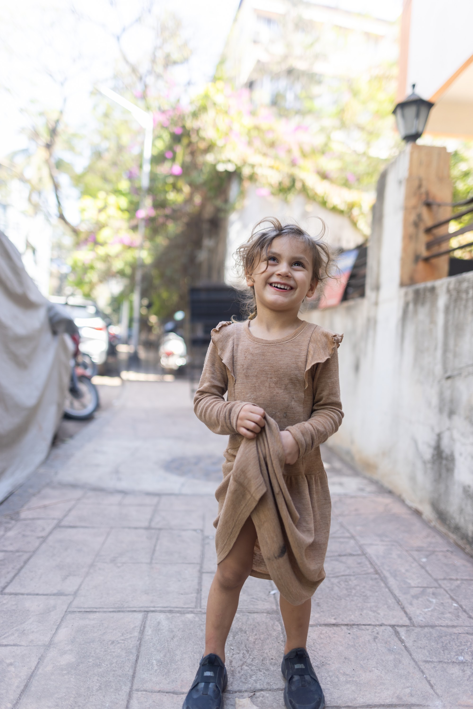 Joyful Girl on Tiled Alley Sidewalk
