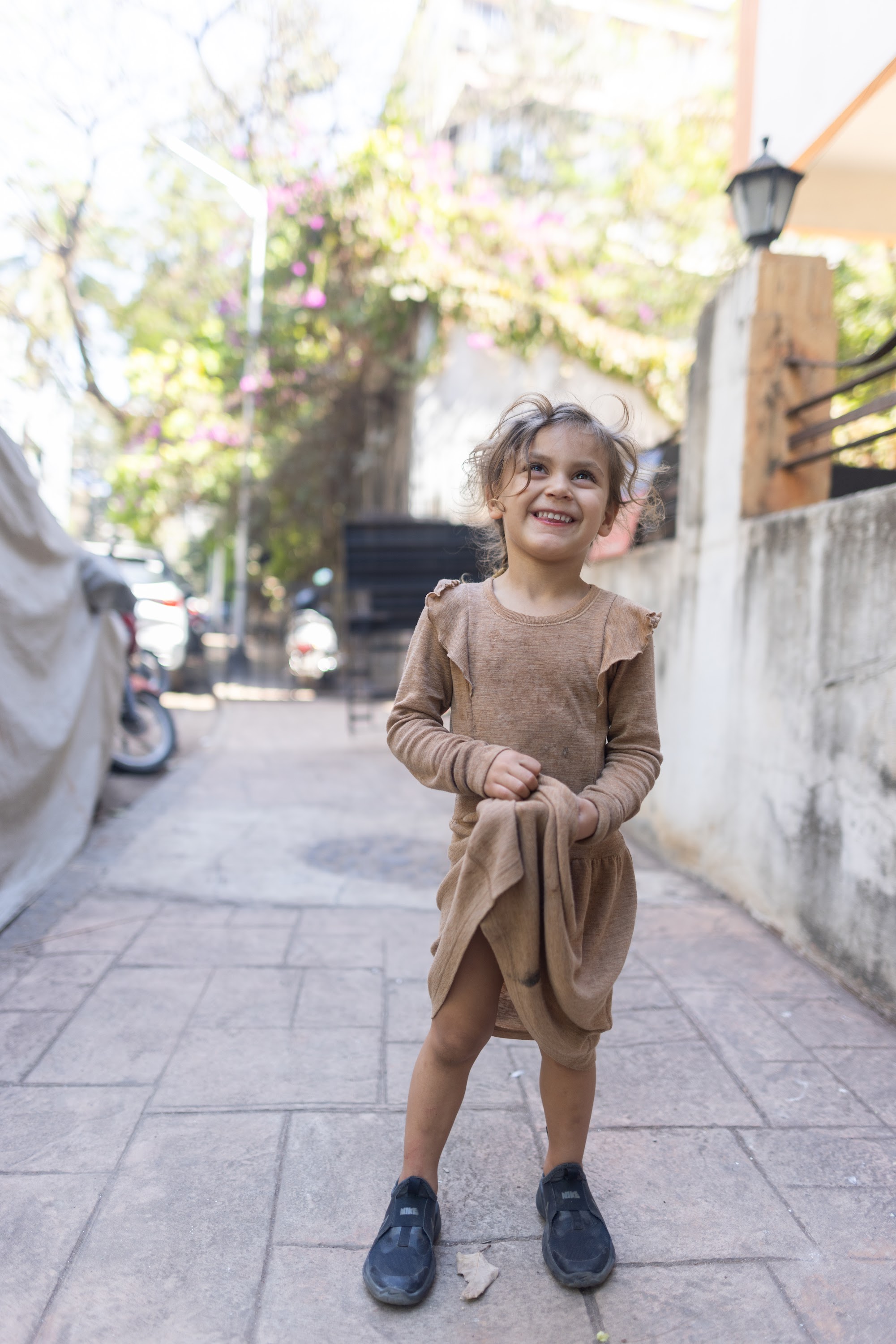 Joyful Girl on Tiled Alley Sidewalk
