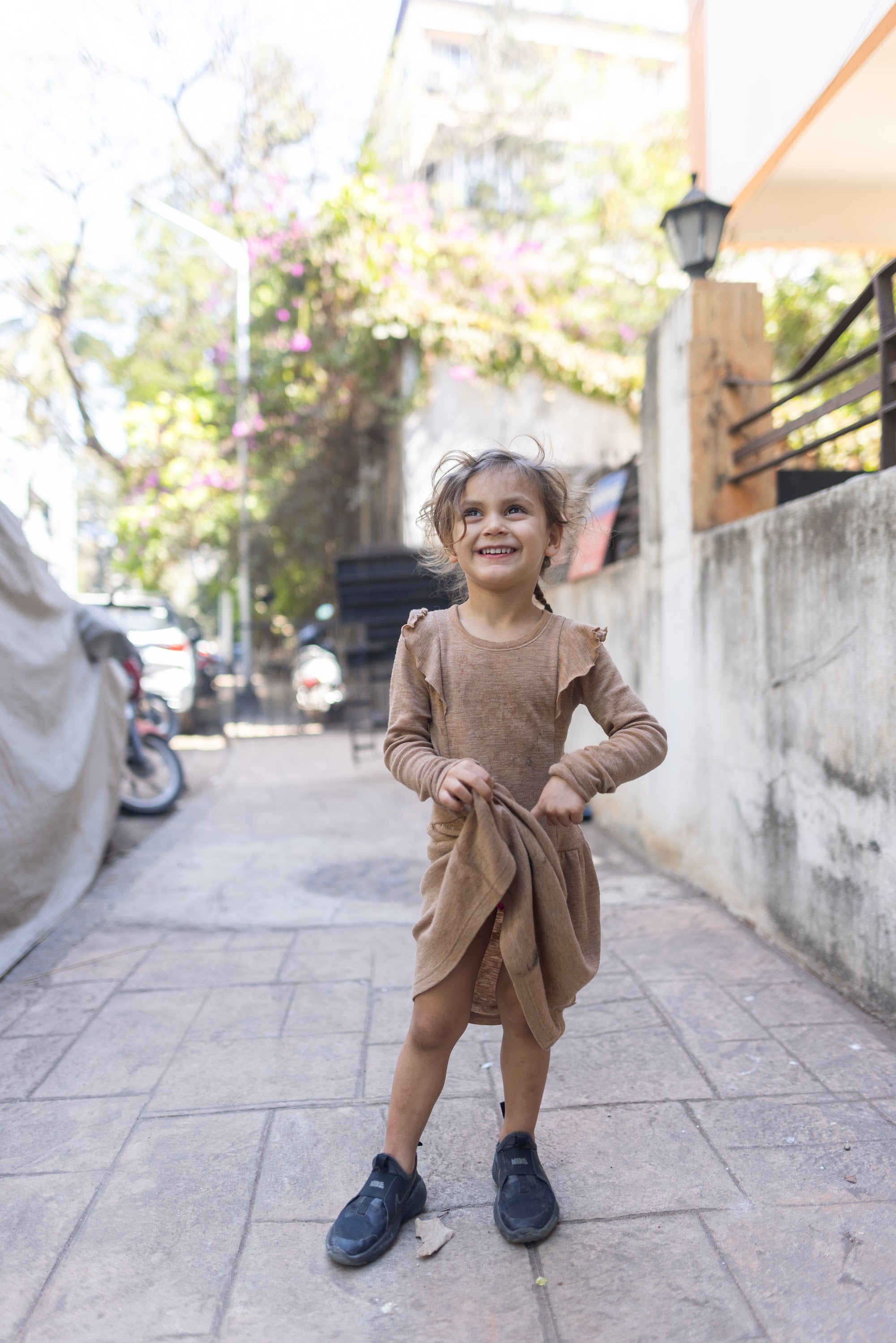 Young Girl Smiling on Urban Alley Sidewalk