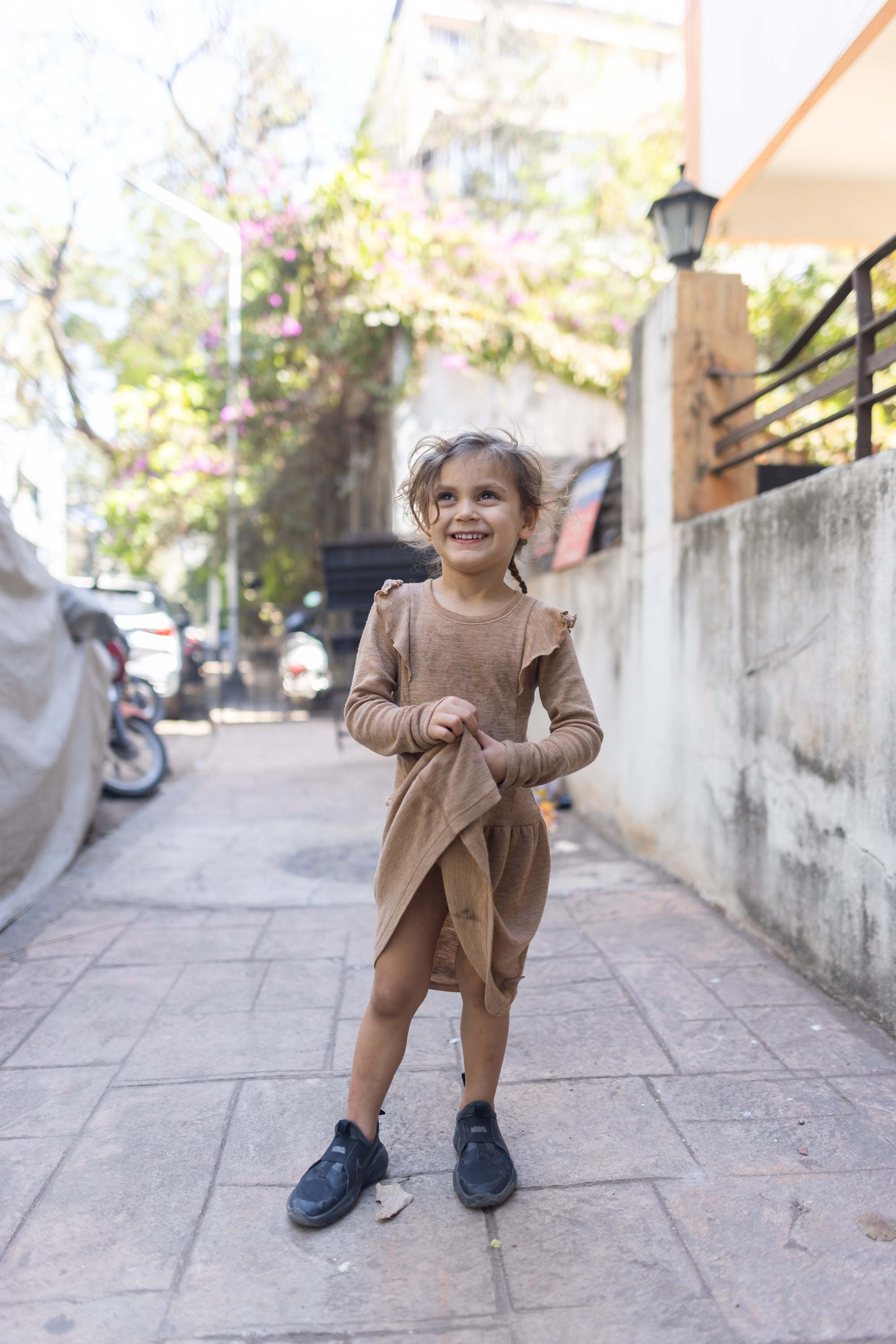 Young Girl Smiling on Urban Alley Sidewalk