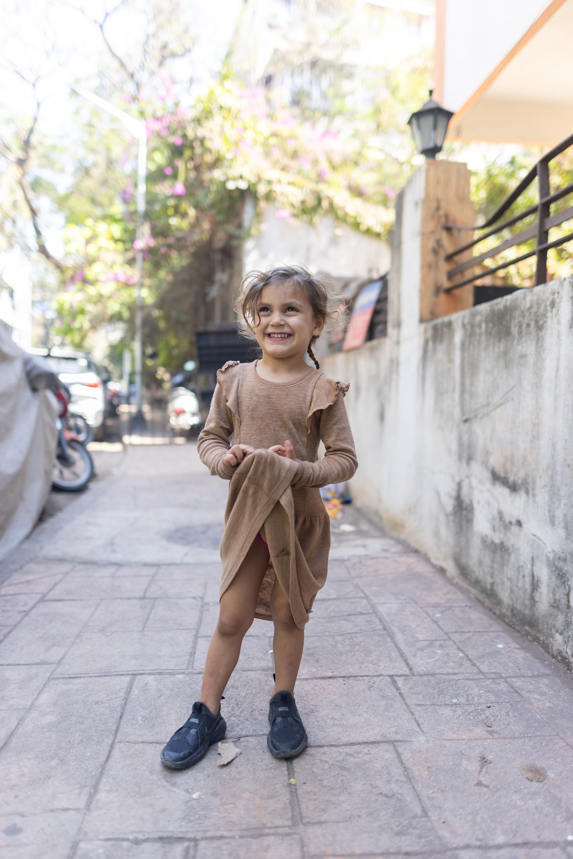 Young Girl Smiling on Urban Alley Sidewalk