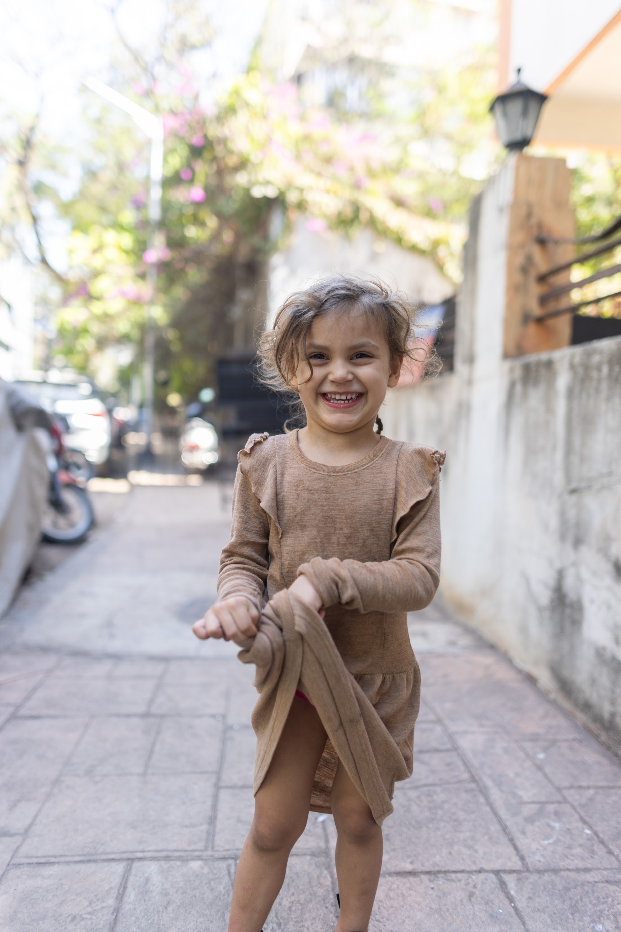 Young Girl Smiling on Urban Alley Sidewalk