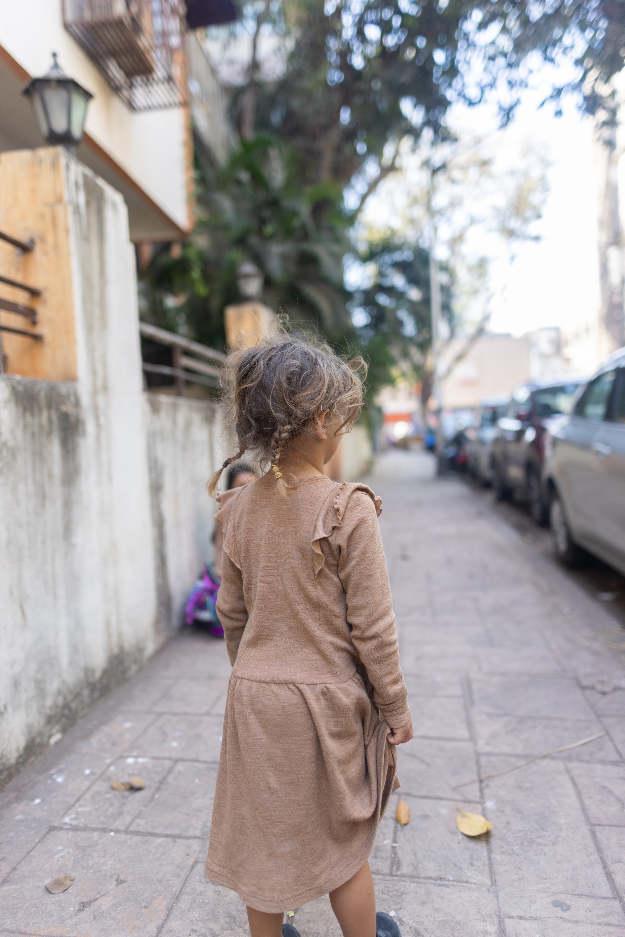 Young Girl Walking Down Urban Alley
