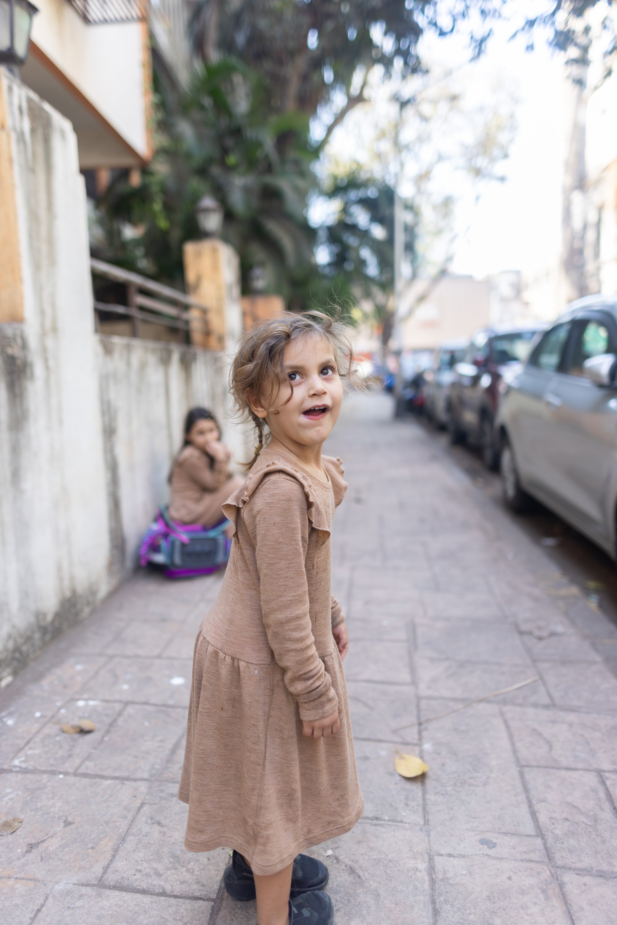 Young Girl Smiling on Urban Alley Sidewalk