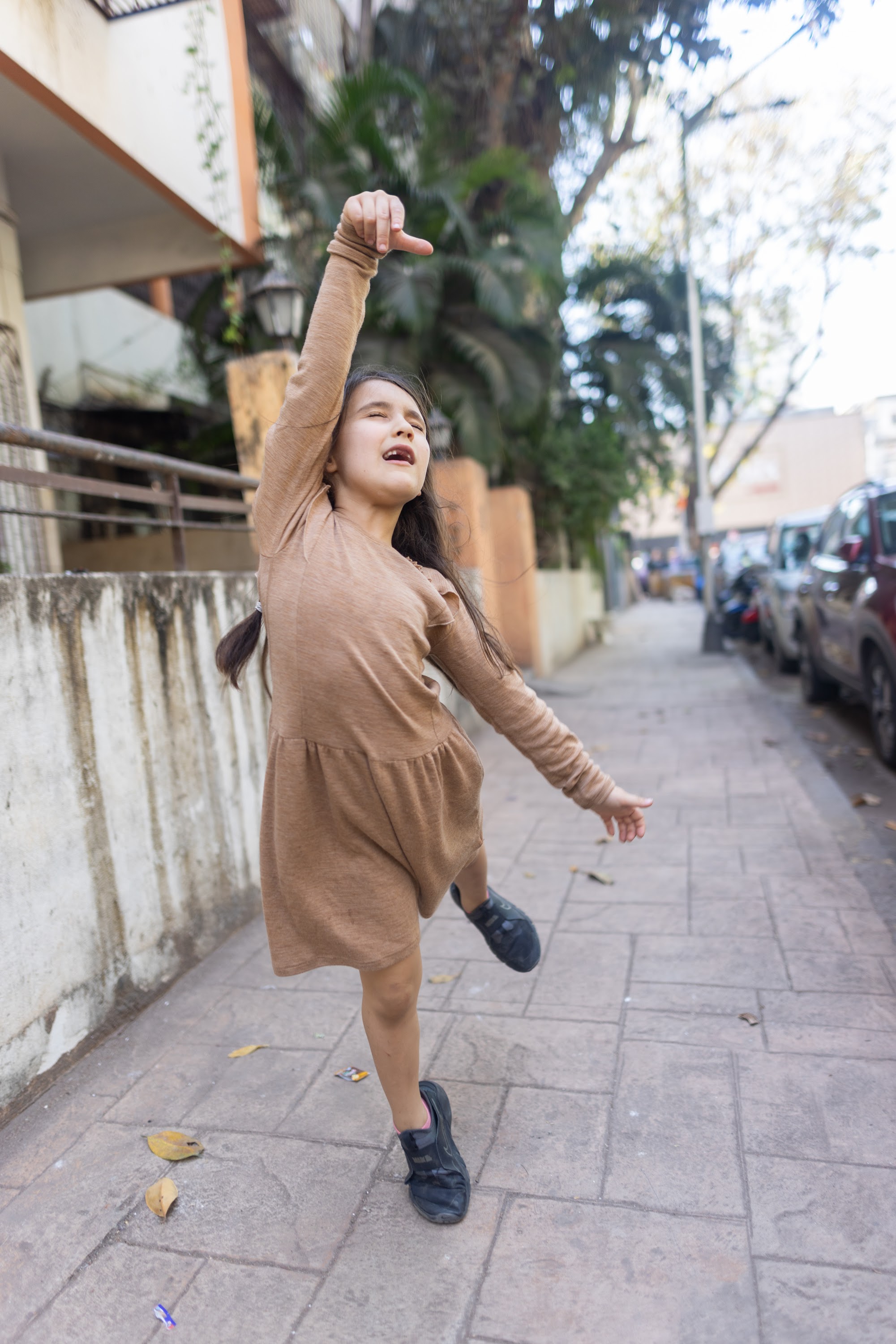 Girl Dancing on Sidewalk
