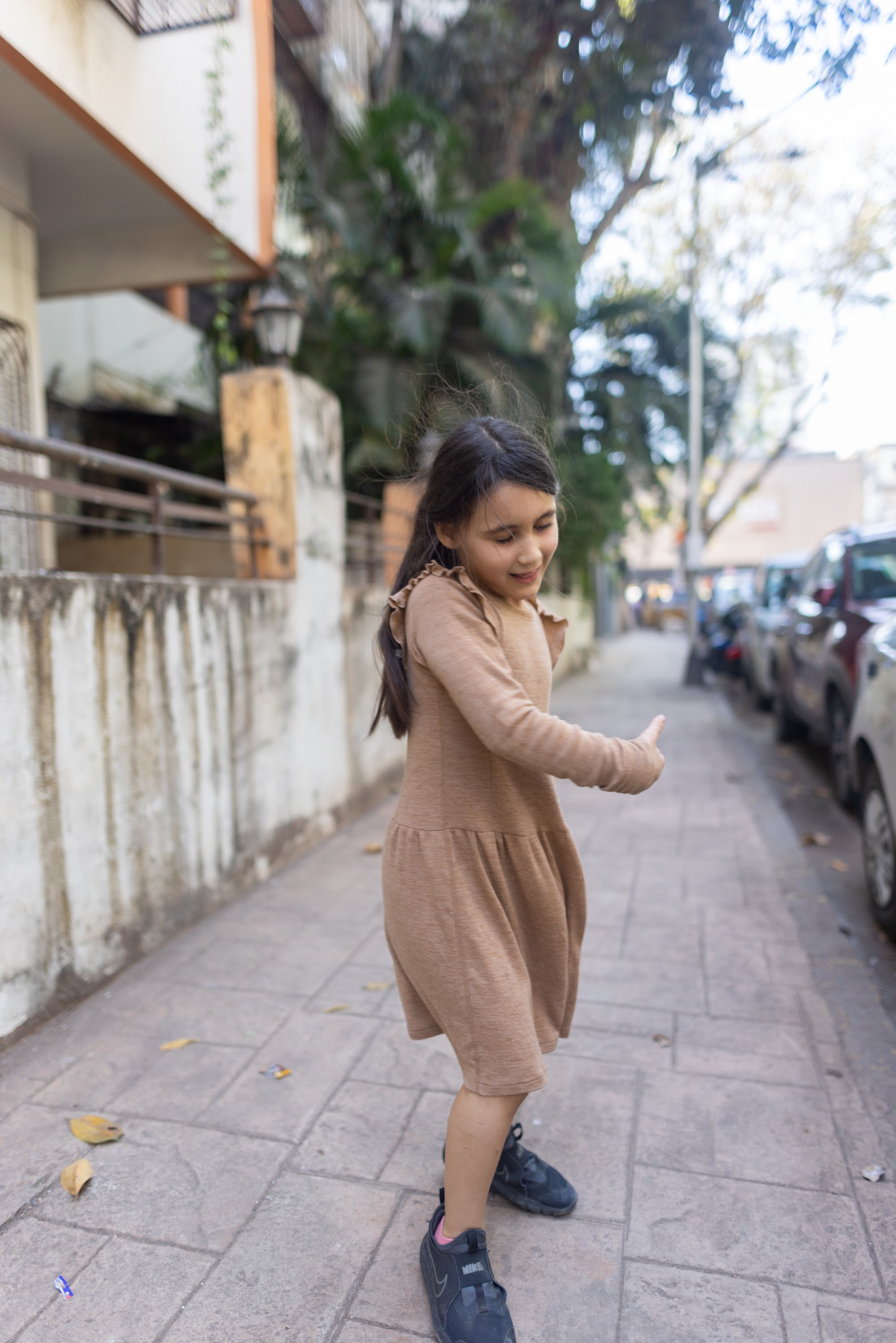 Young Girl Smiling on Urban Alley Sidewalk