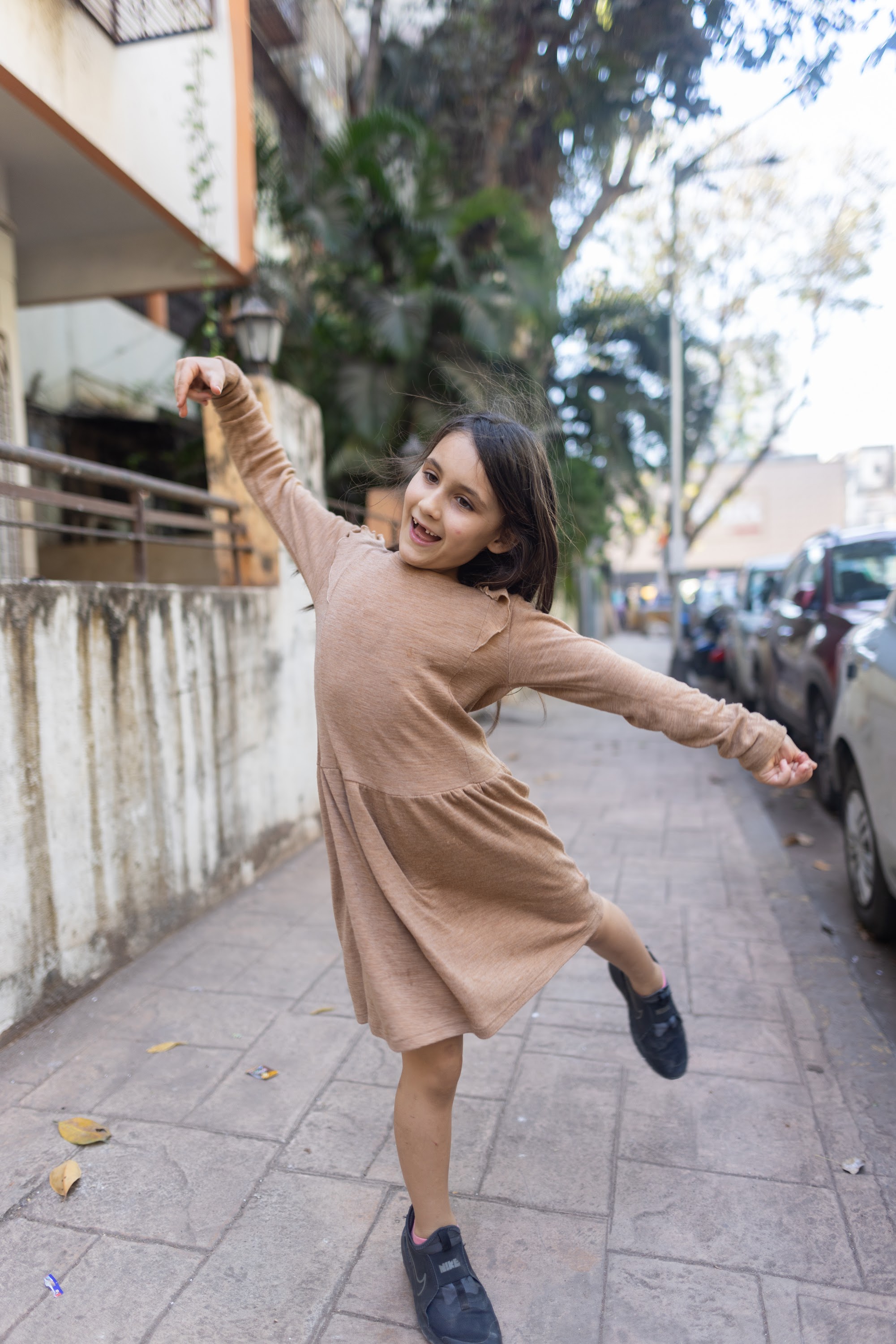Girl Dancing on a City Sidewalk