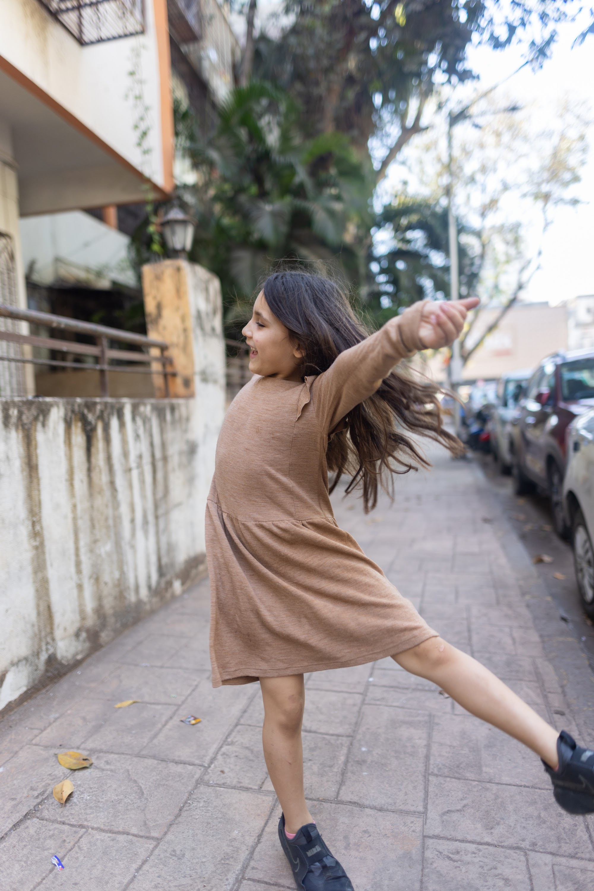 Young Girl Dancing on Sidewalk
