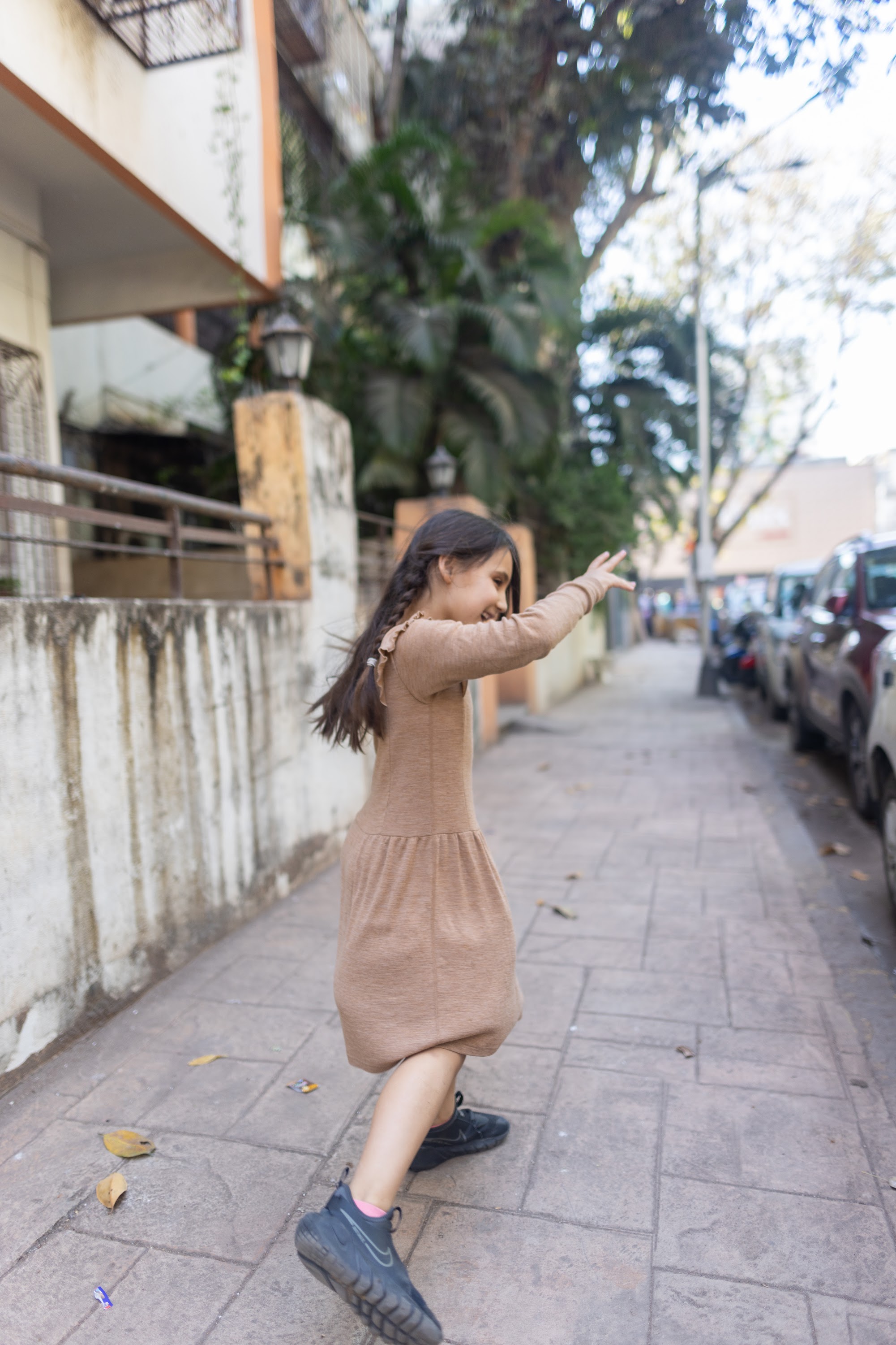 Young Girl Smiling on Urban Alley Sidewalk