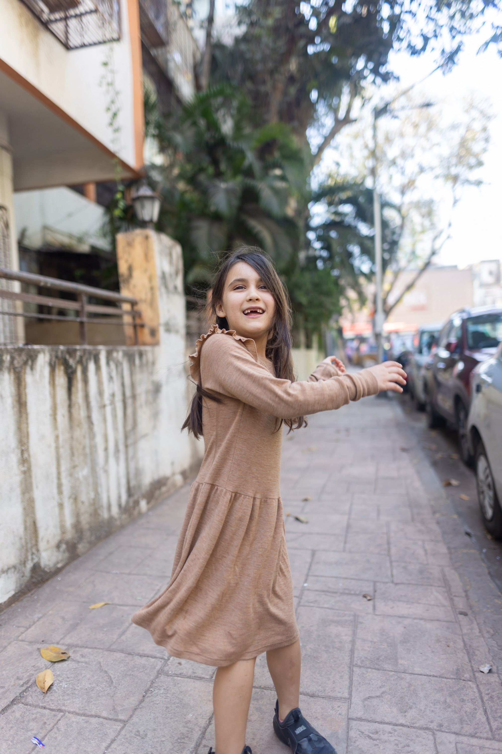 Girl Dancing on a City Sidewalk