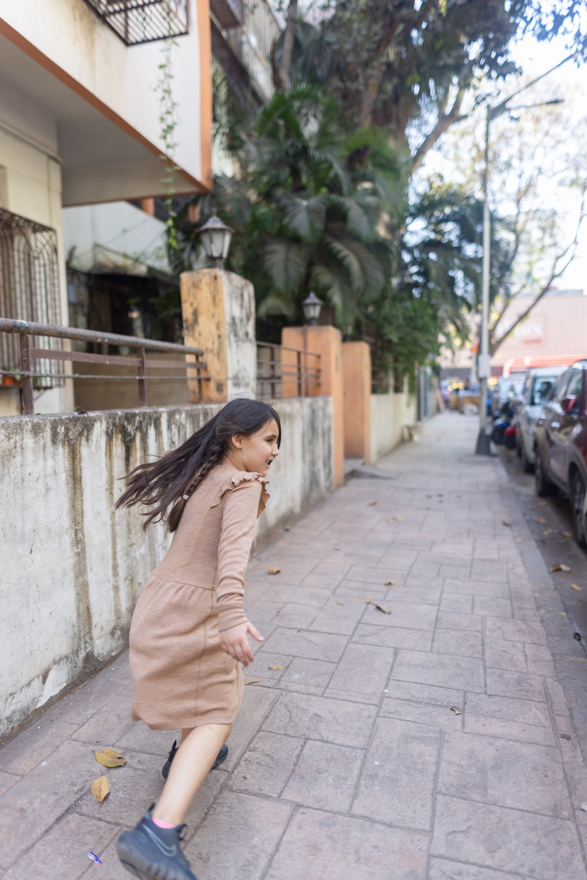 Girl Running on a City Sidewalk