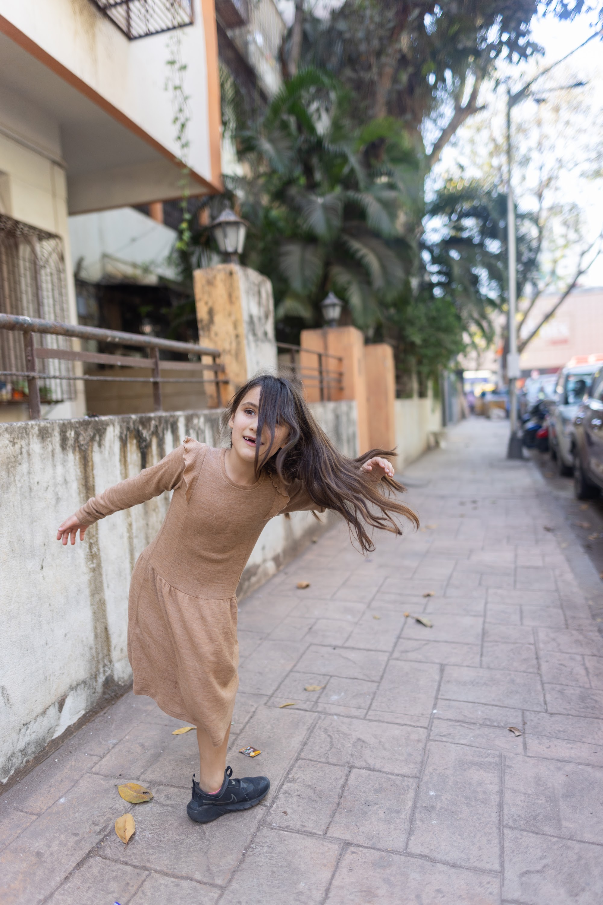 Girl Spinning on a Sidewalk