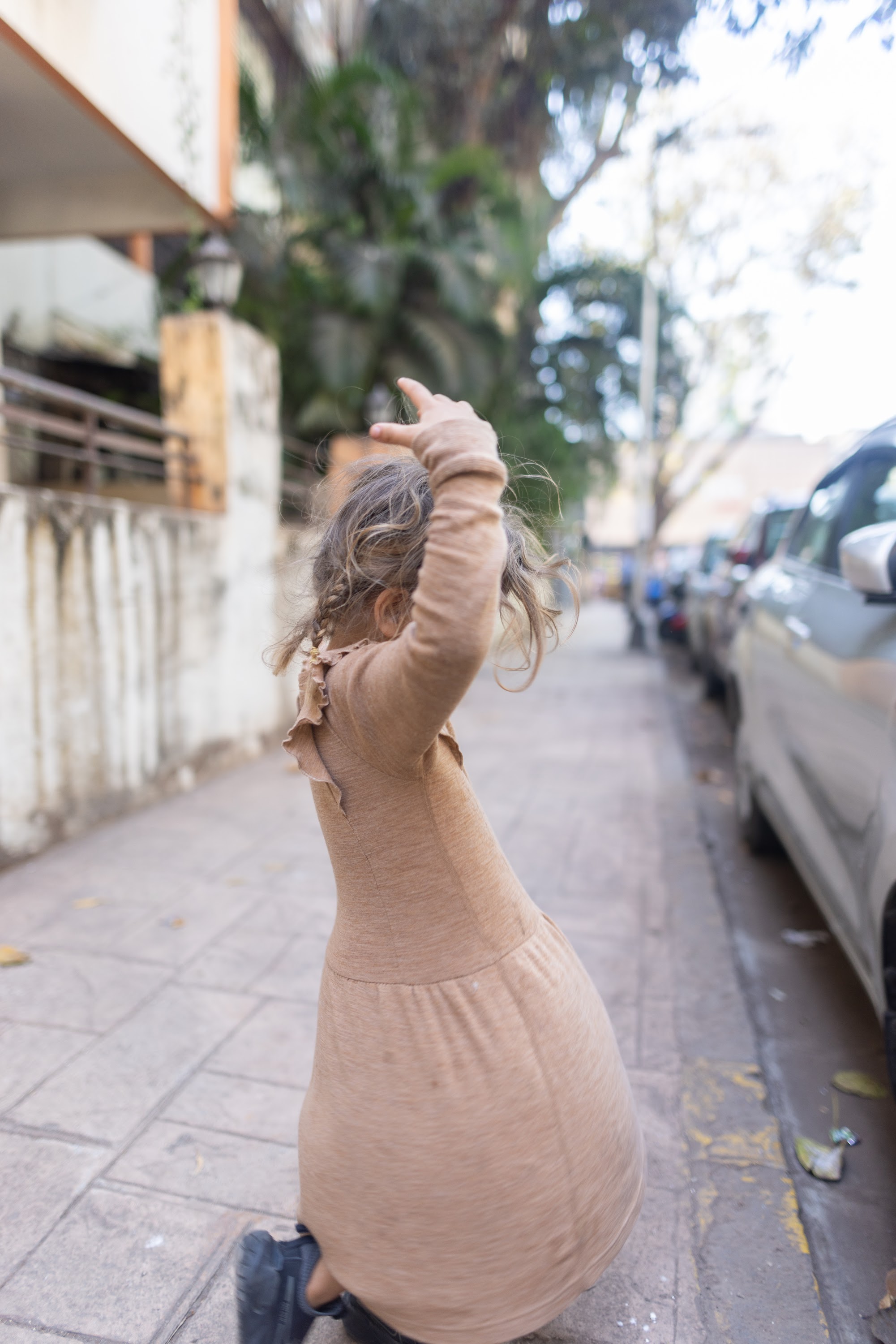 Child Playing on Sidewalk