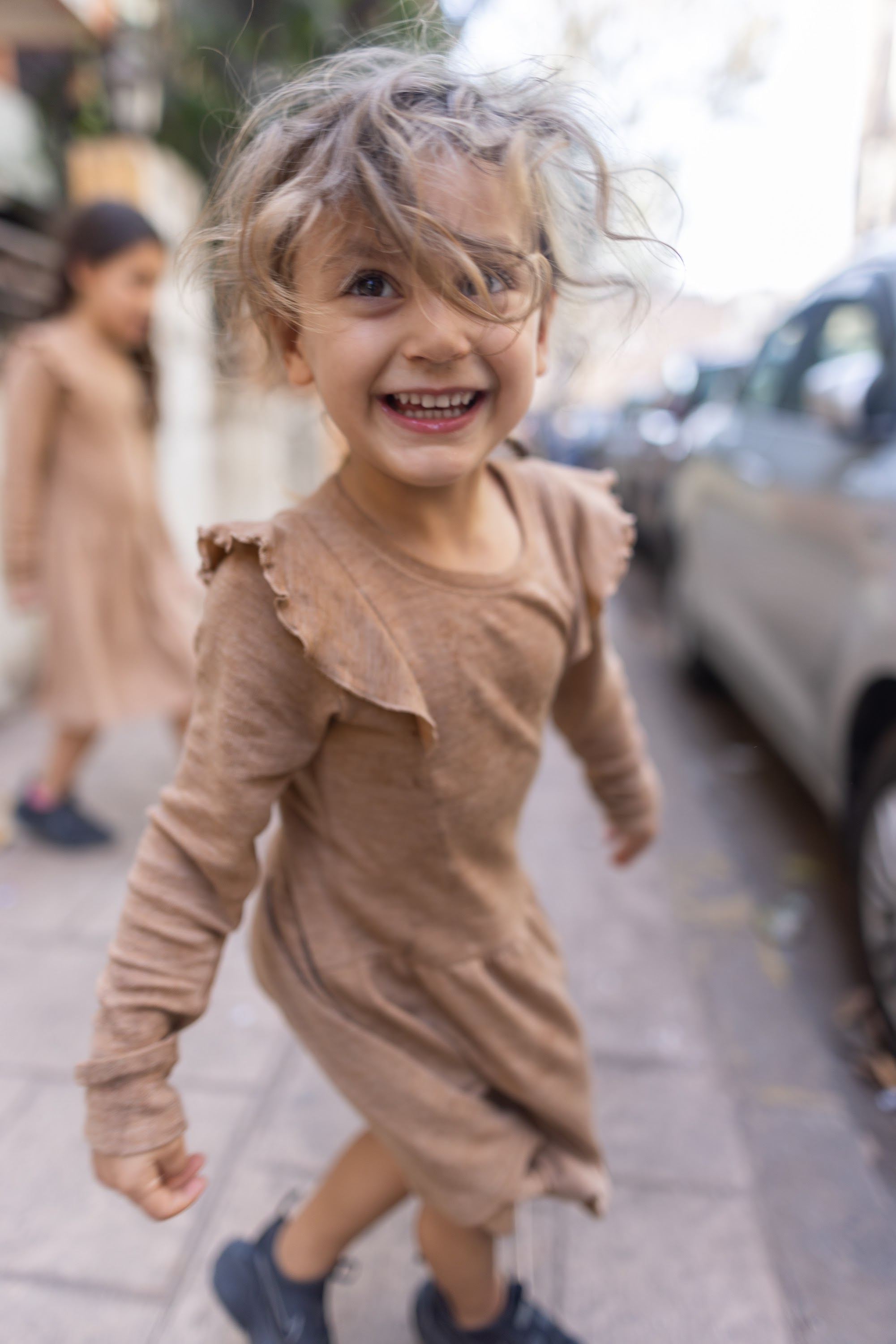 Smiling Child Running on Street