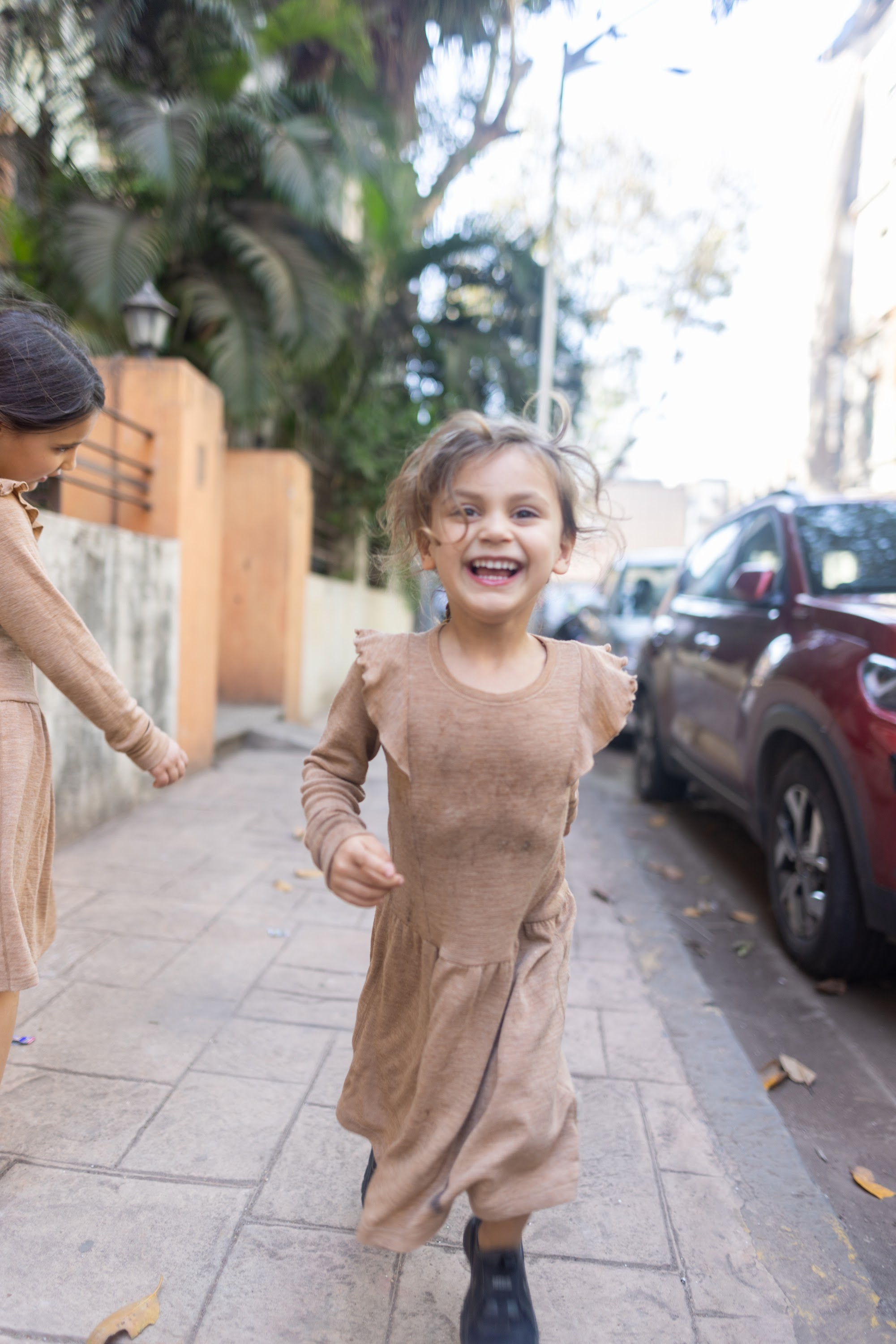 Happy Child Running on Sidewalk