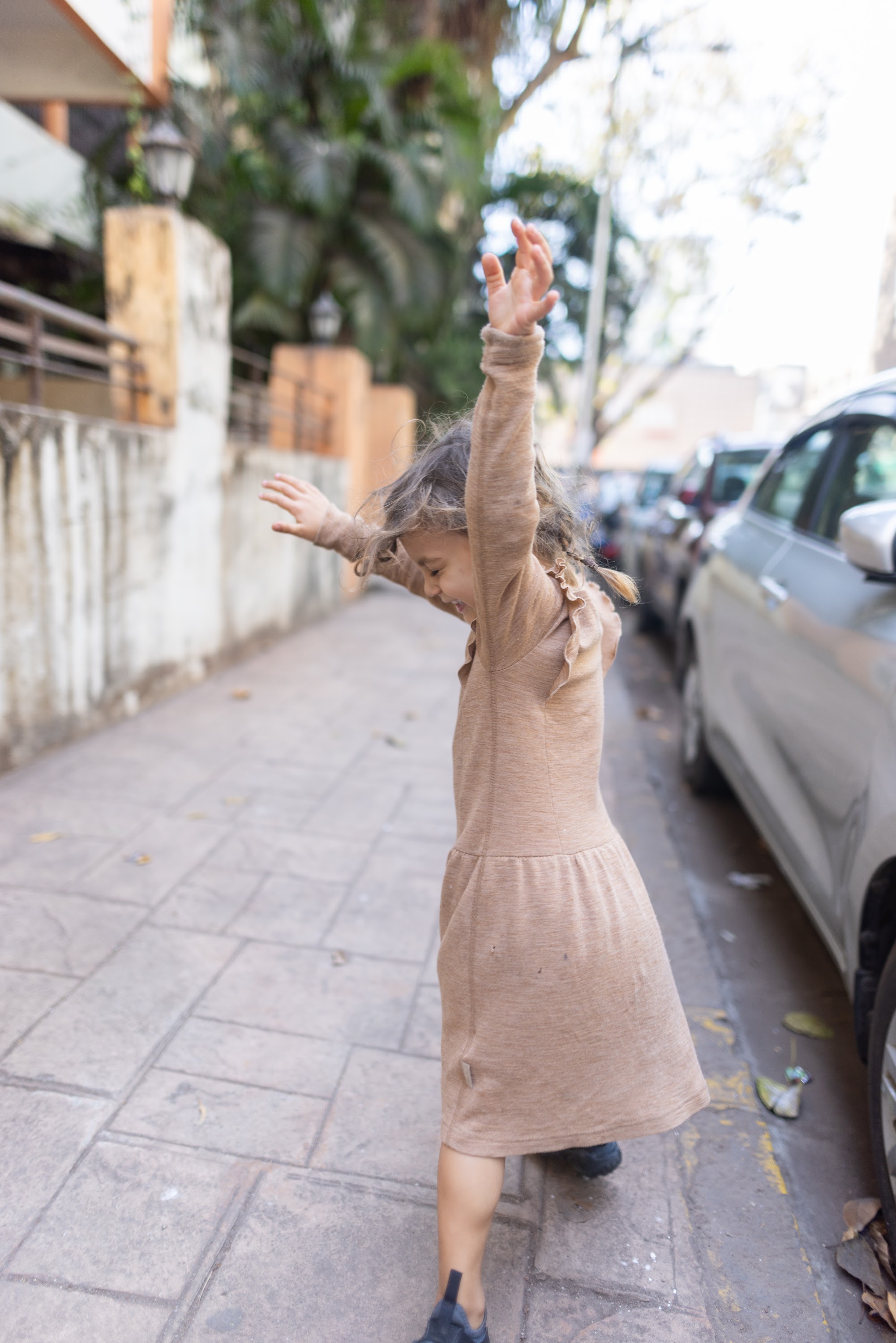 Child Dancing on Sidewalk