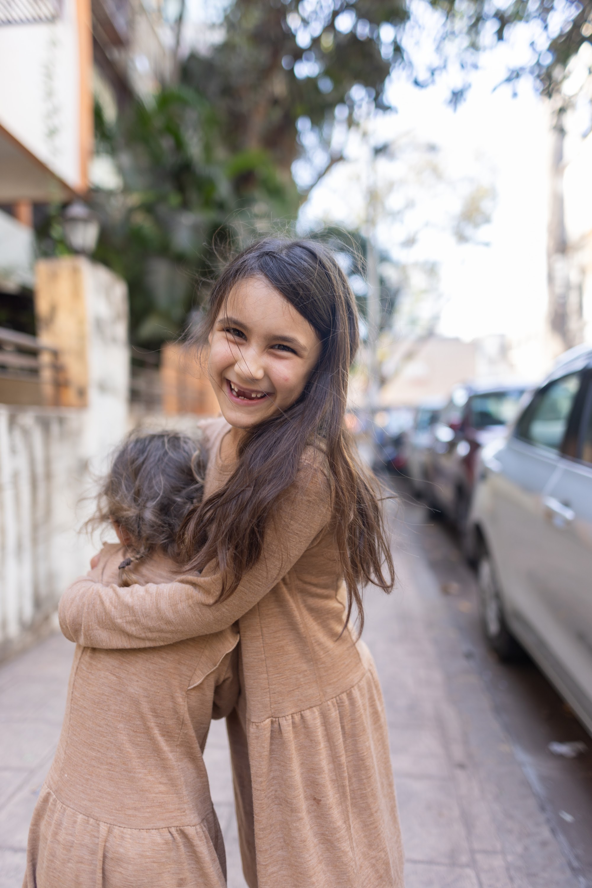Sibling Hug on a City Street