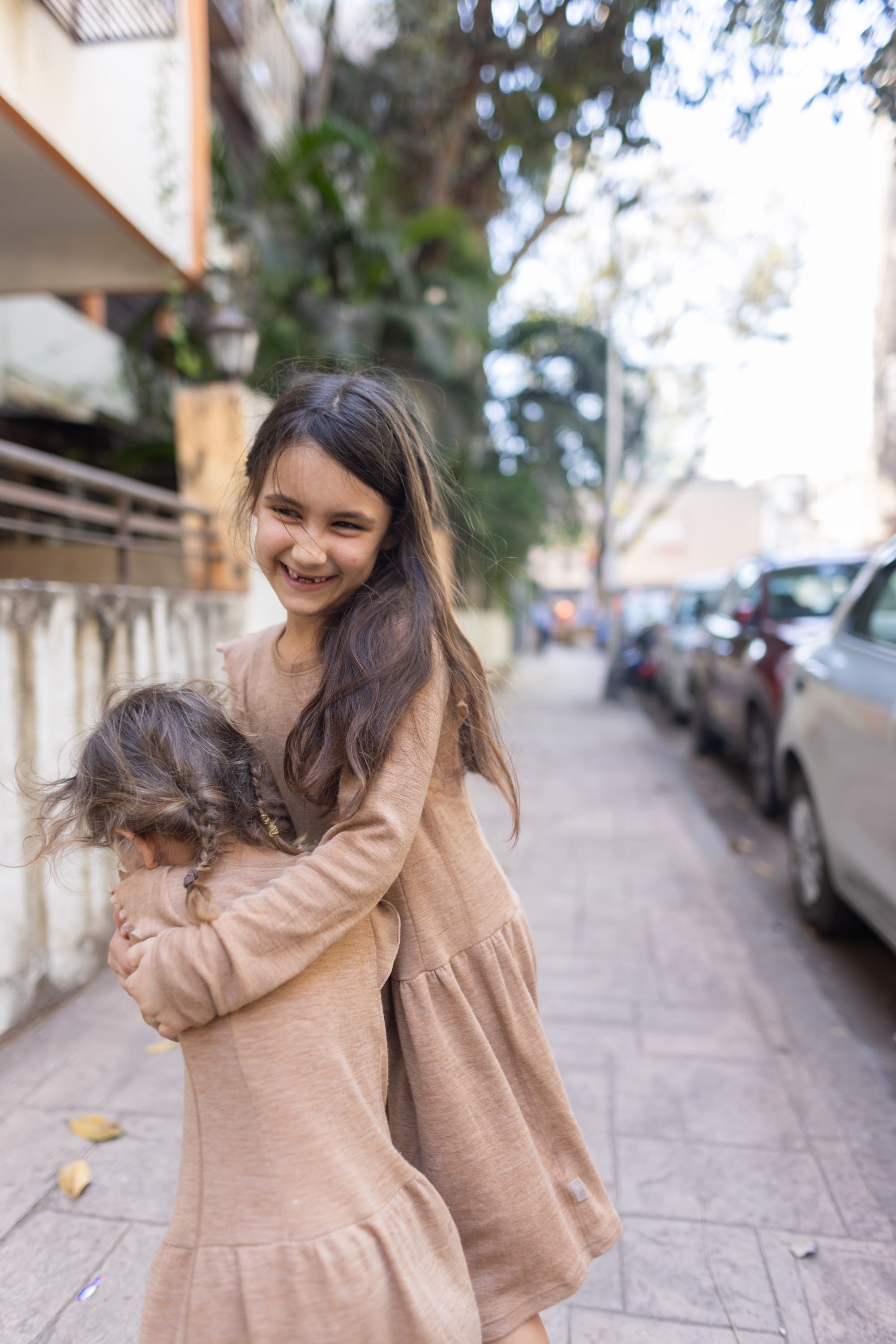 Sibling Hug on a City Street