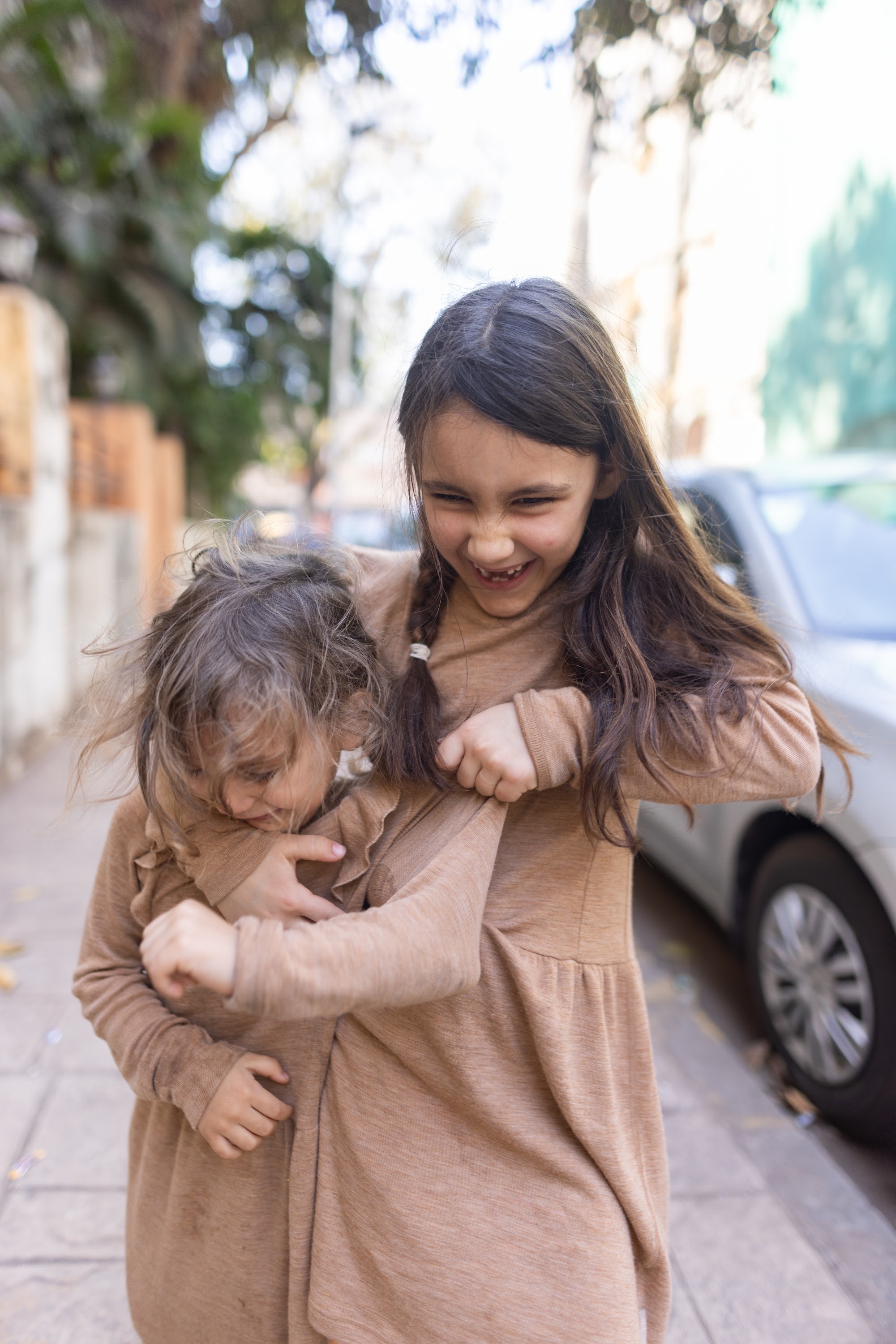 Sibling Hugs on the Sidewalk