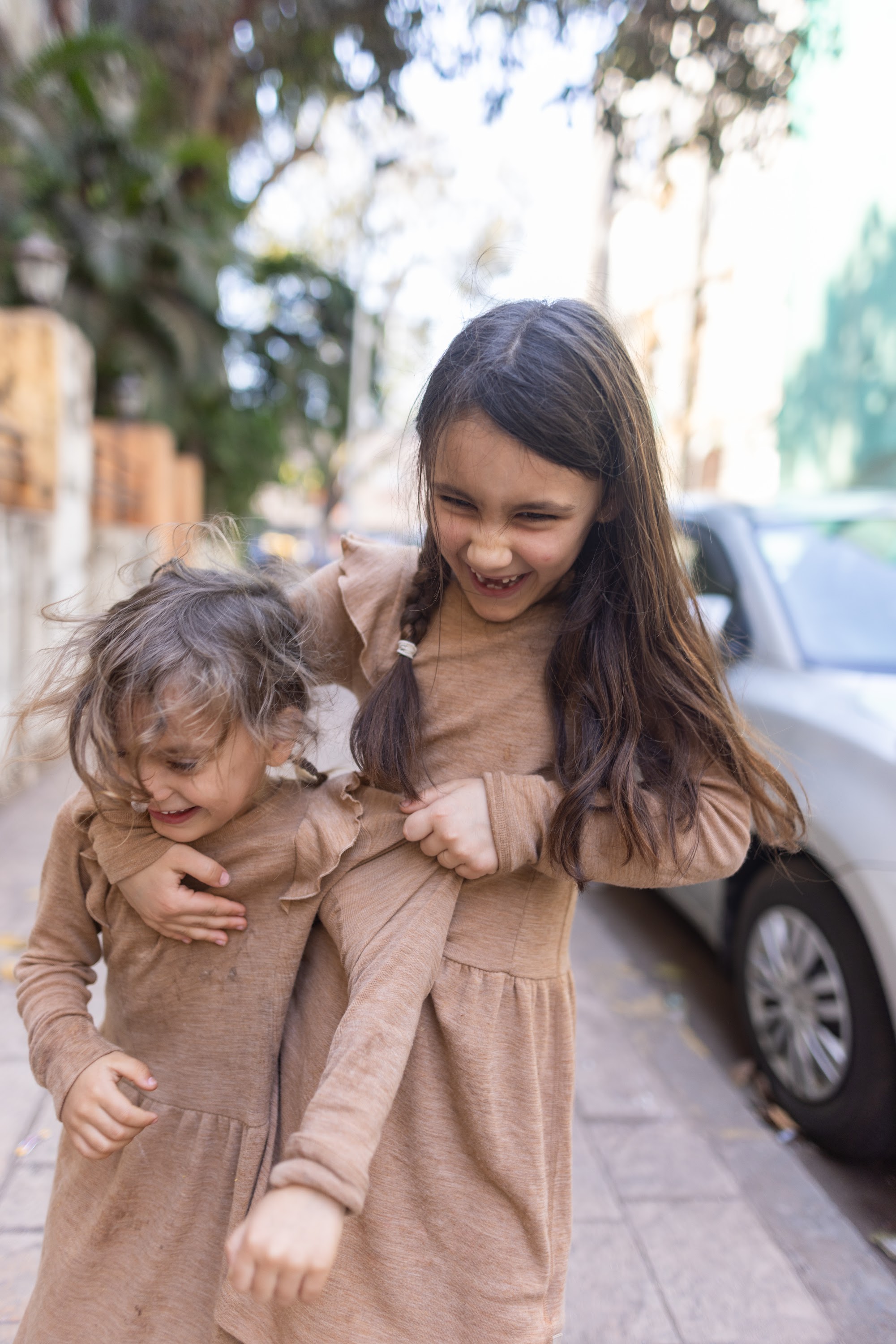 Two Girls Laughing on a City Street
