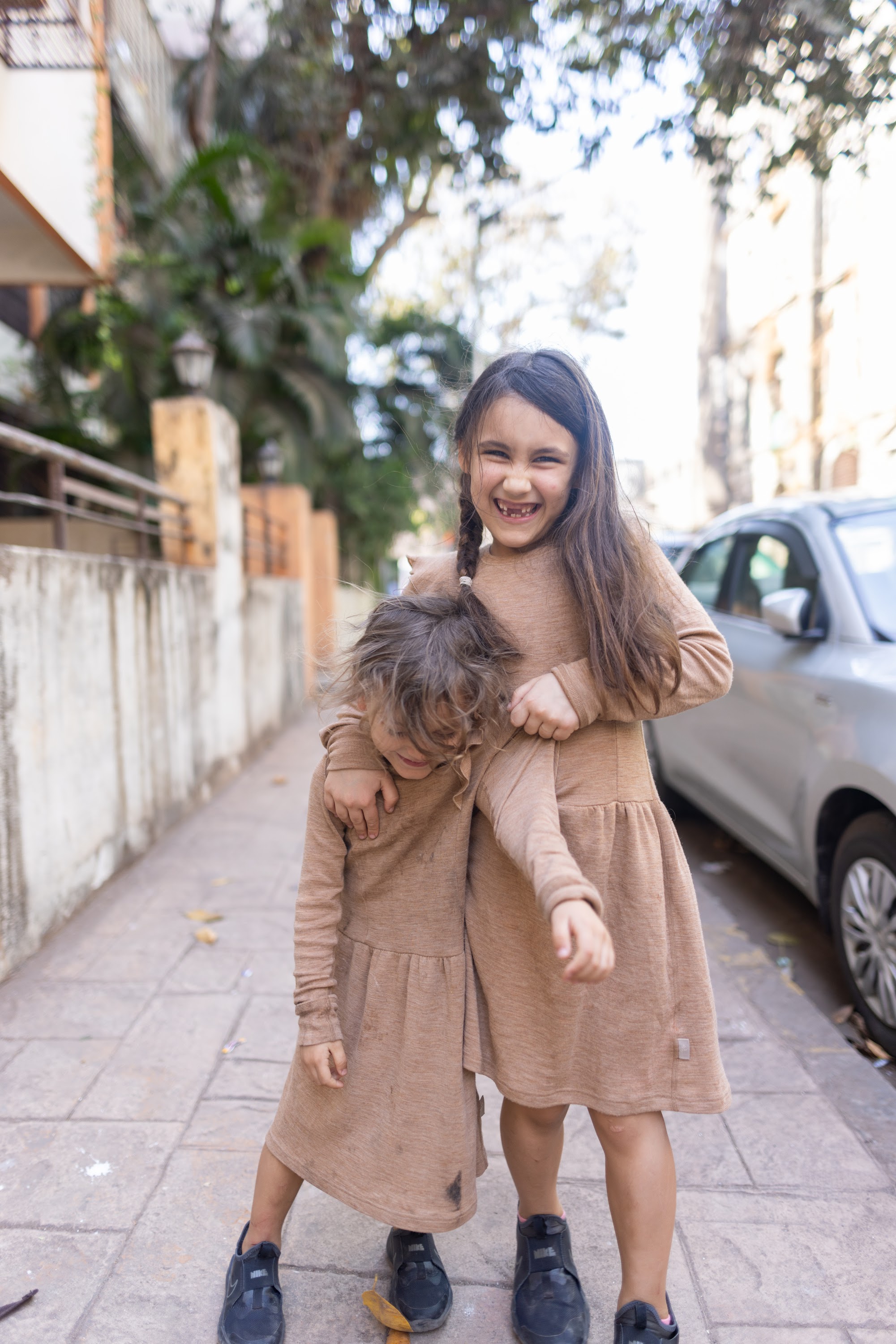 Two Girls Playing on a Sidewalk