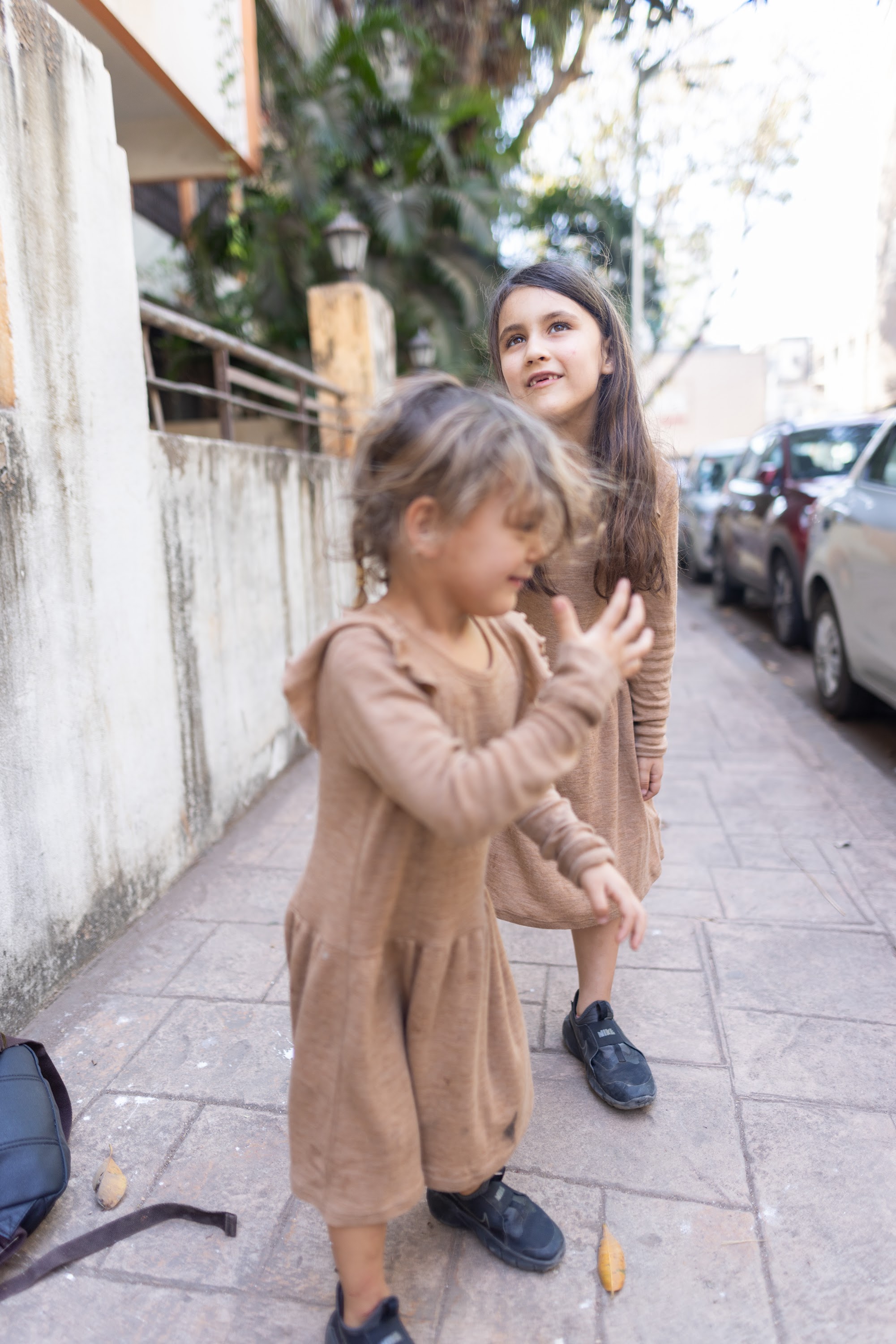 Two Girls Playing on a Sidewalk
