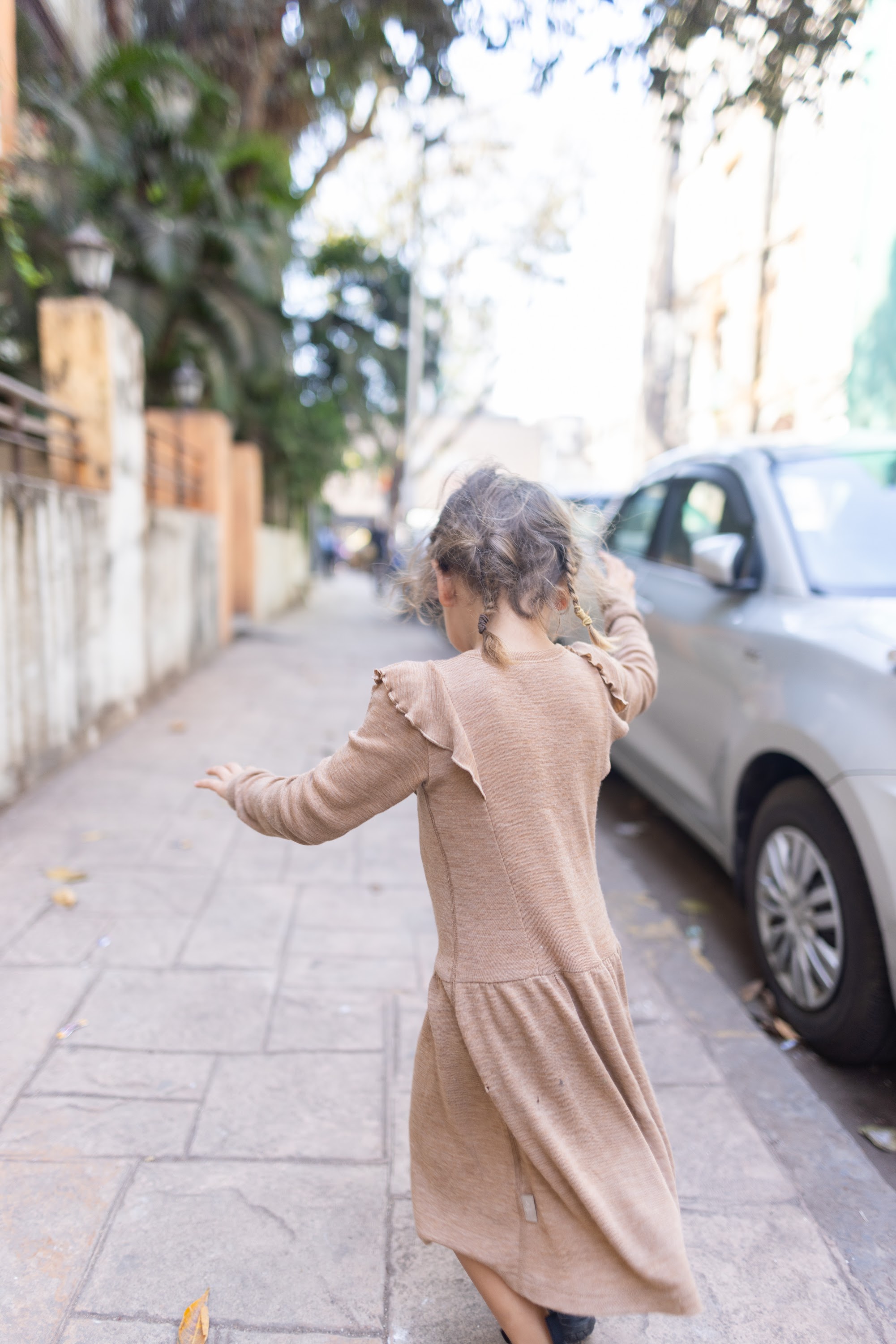 Girl Running Down a Sidewalk