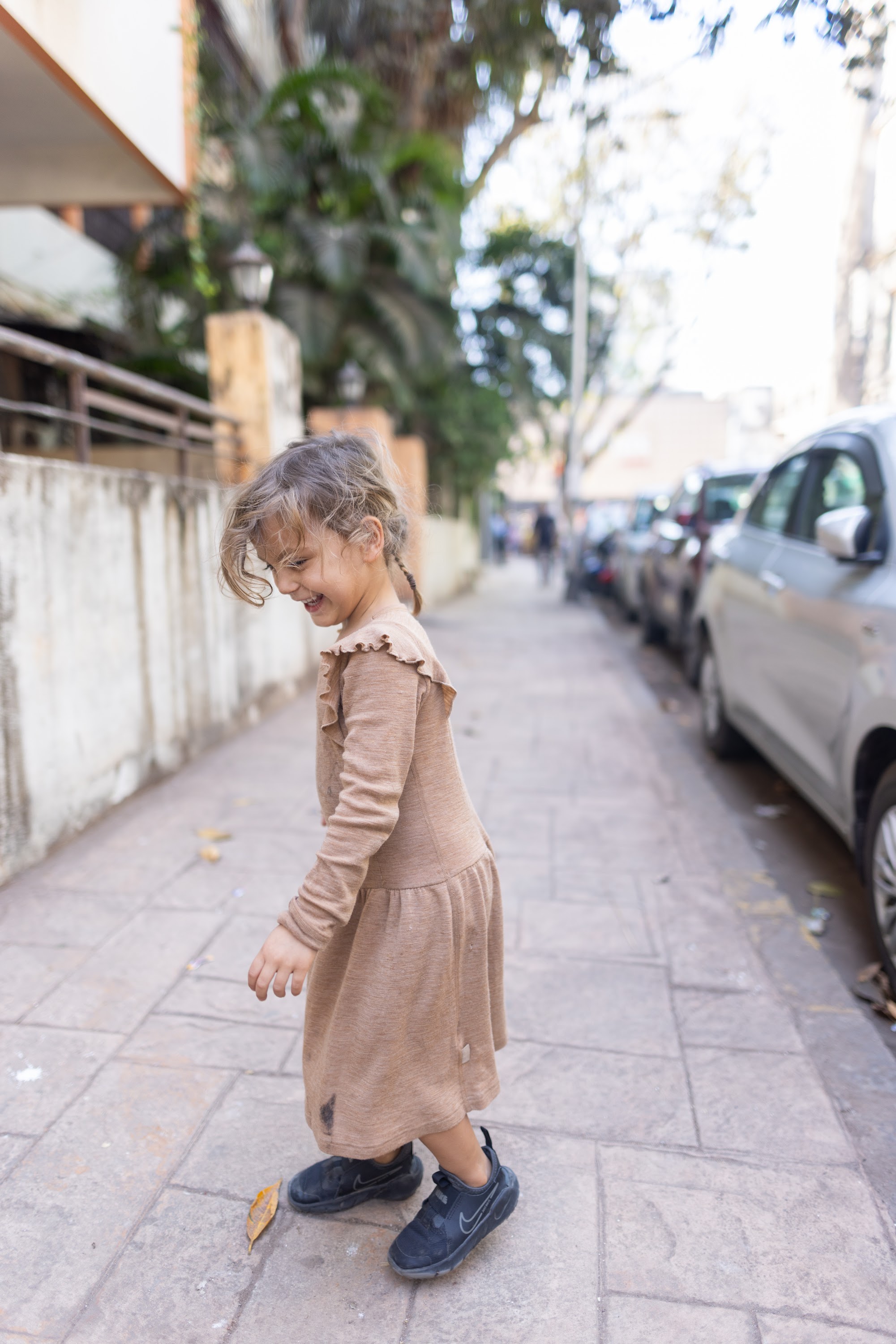 Child Walking on Sidewalk