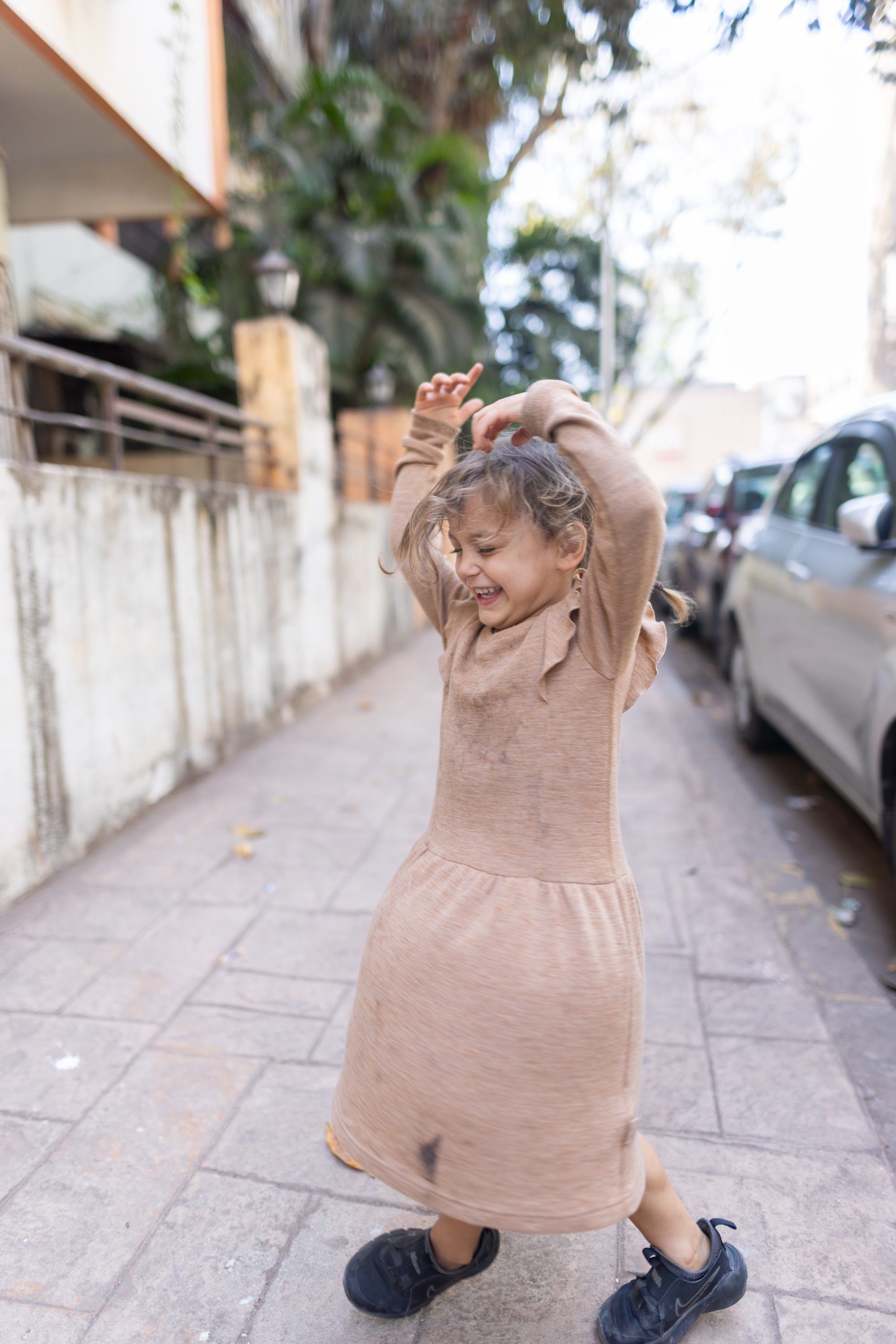 Child Dancing on Sidewalk