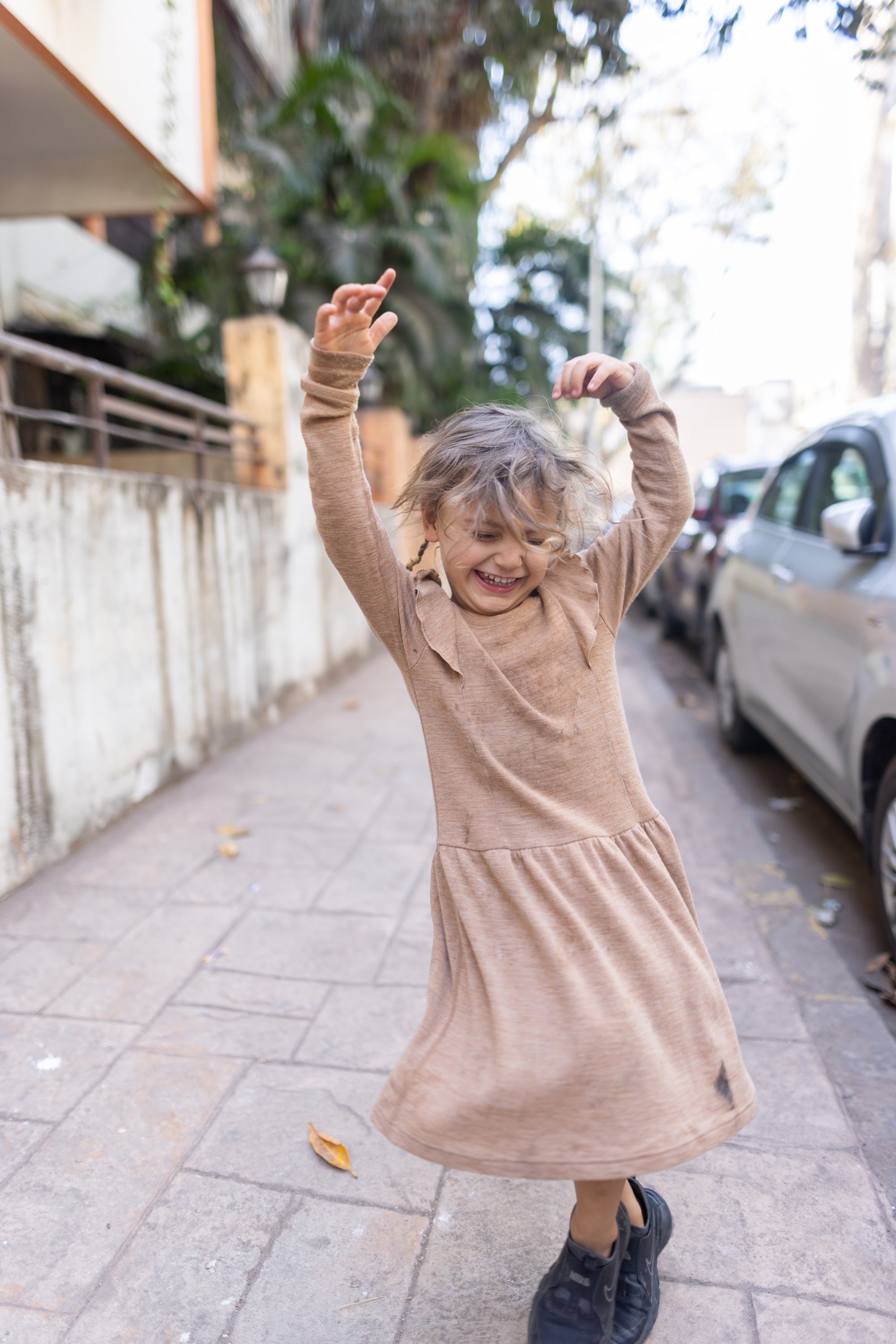 Happy Child Dancing on Sidewalk