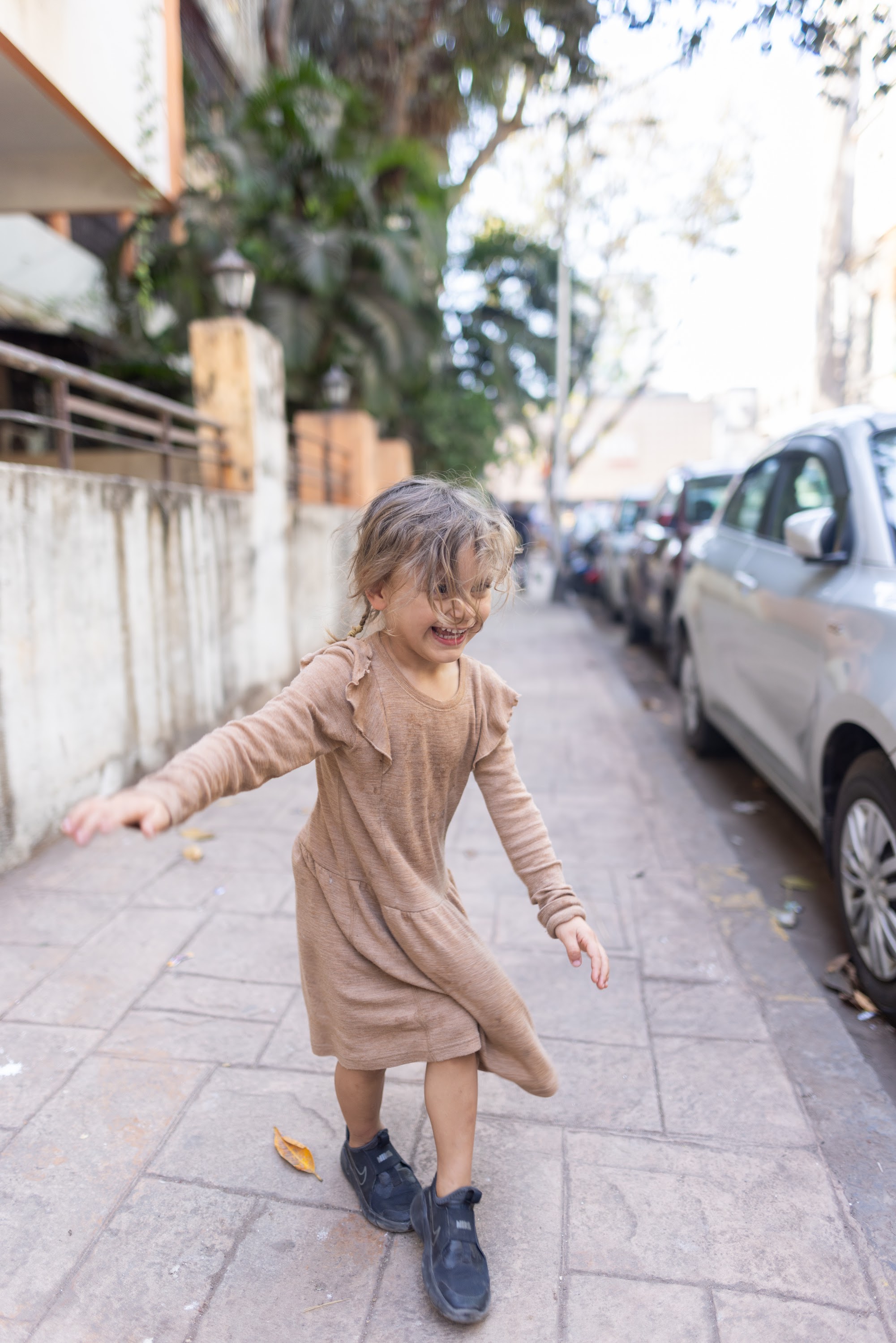 Child Dancing on Sidewalk