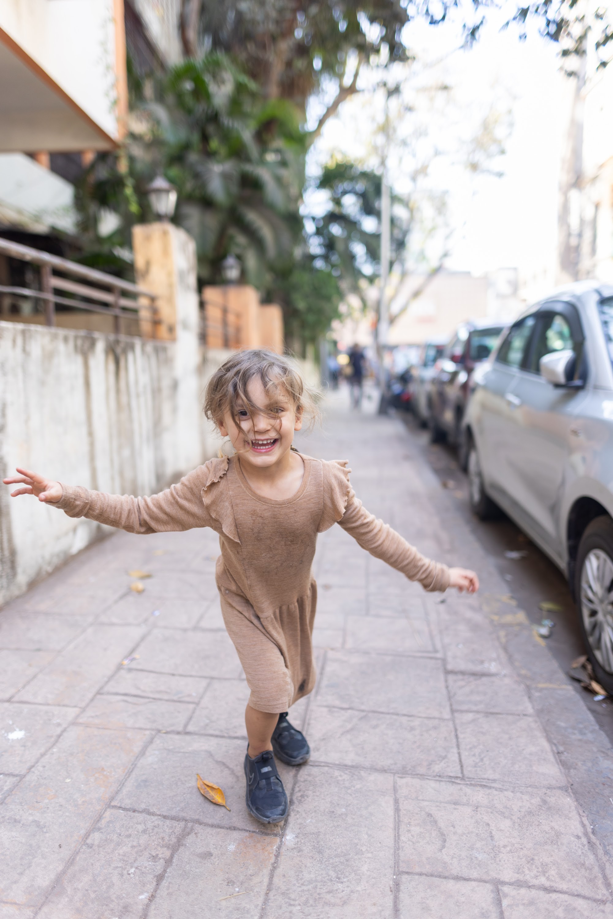 Happy Child Running on Sidewalk