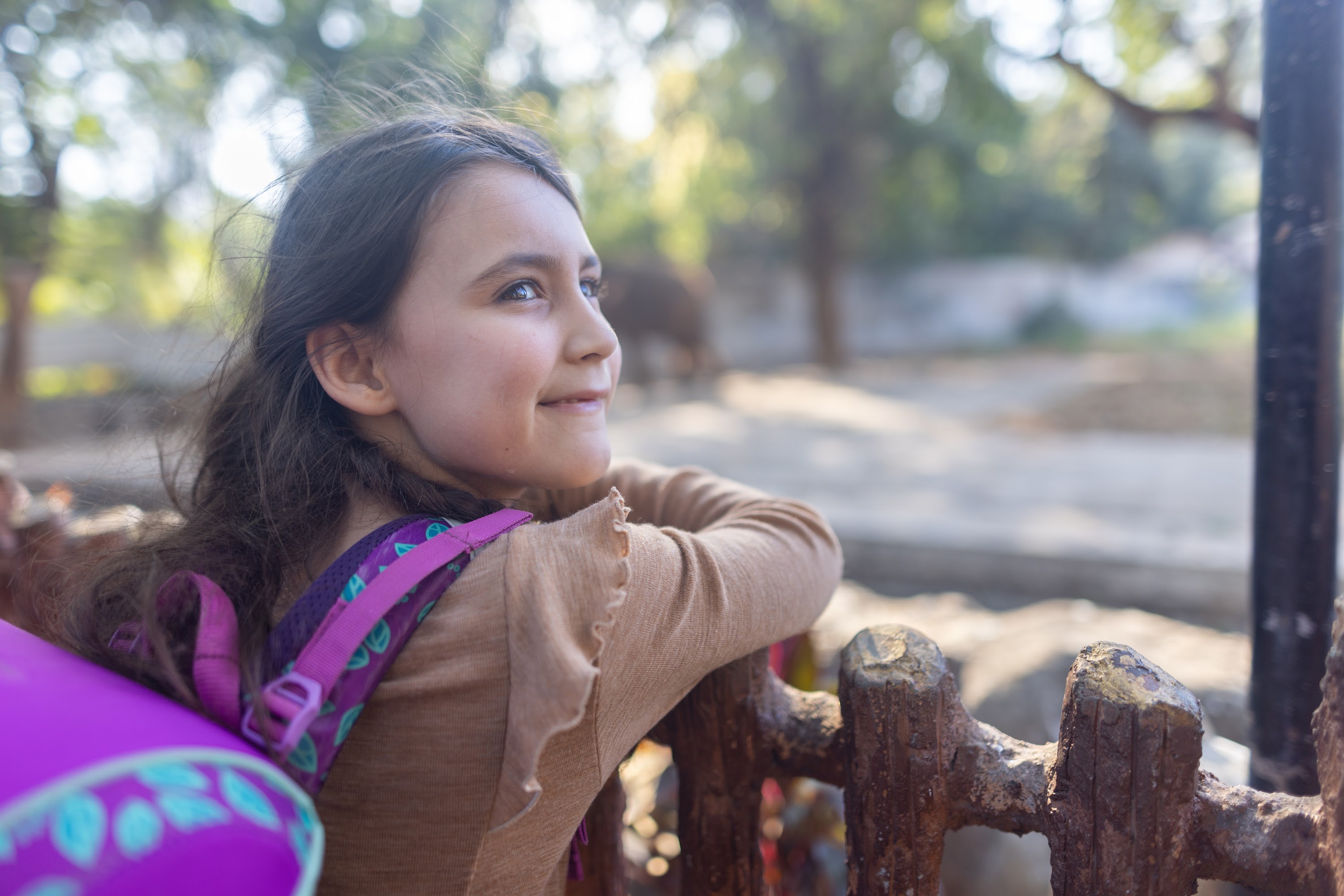 Girl Leaning on Fence at Zoo
