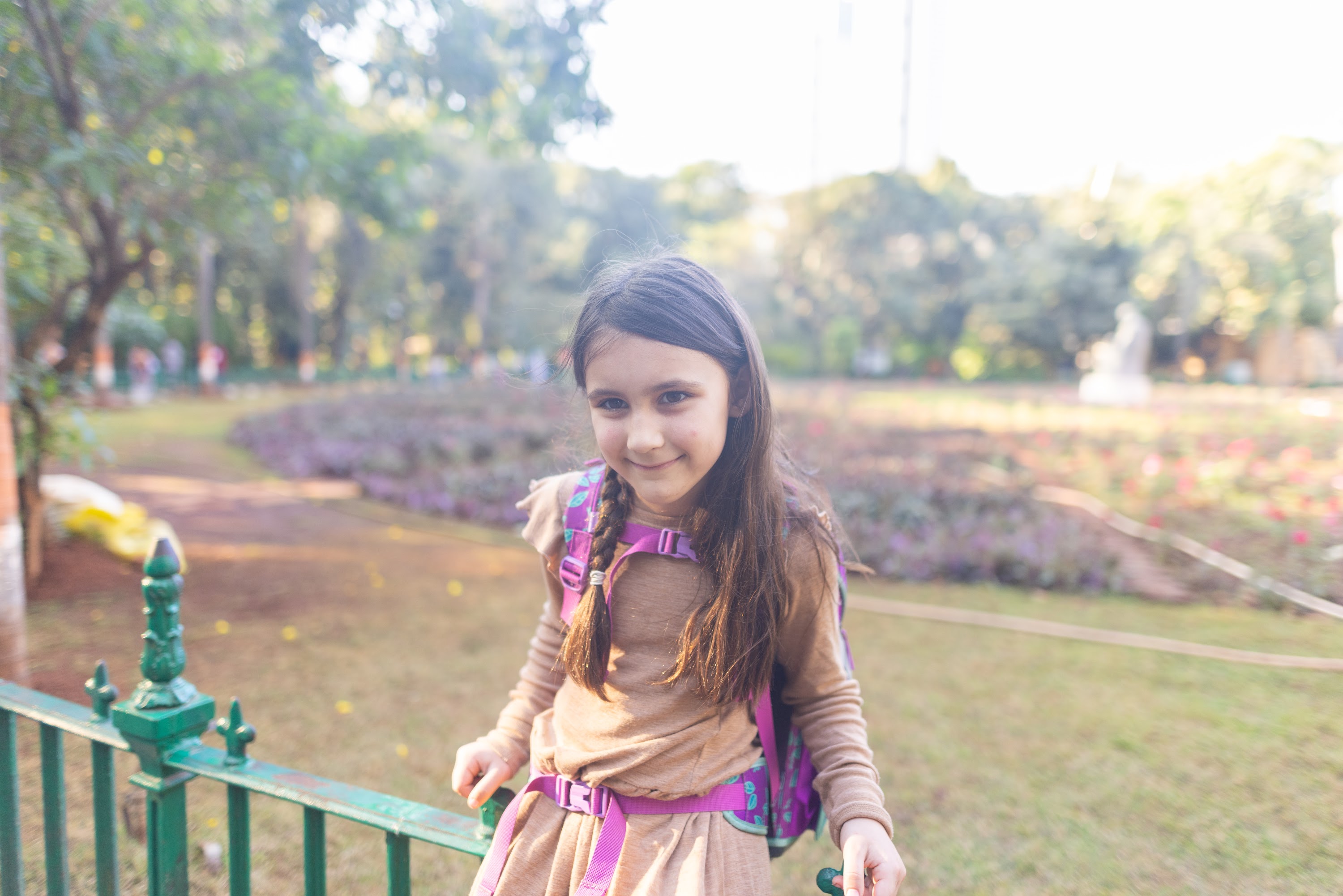 Smiling Girl in Park with Backpack