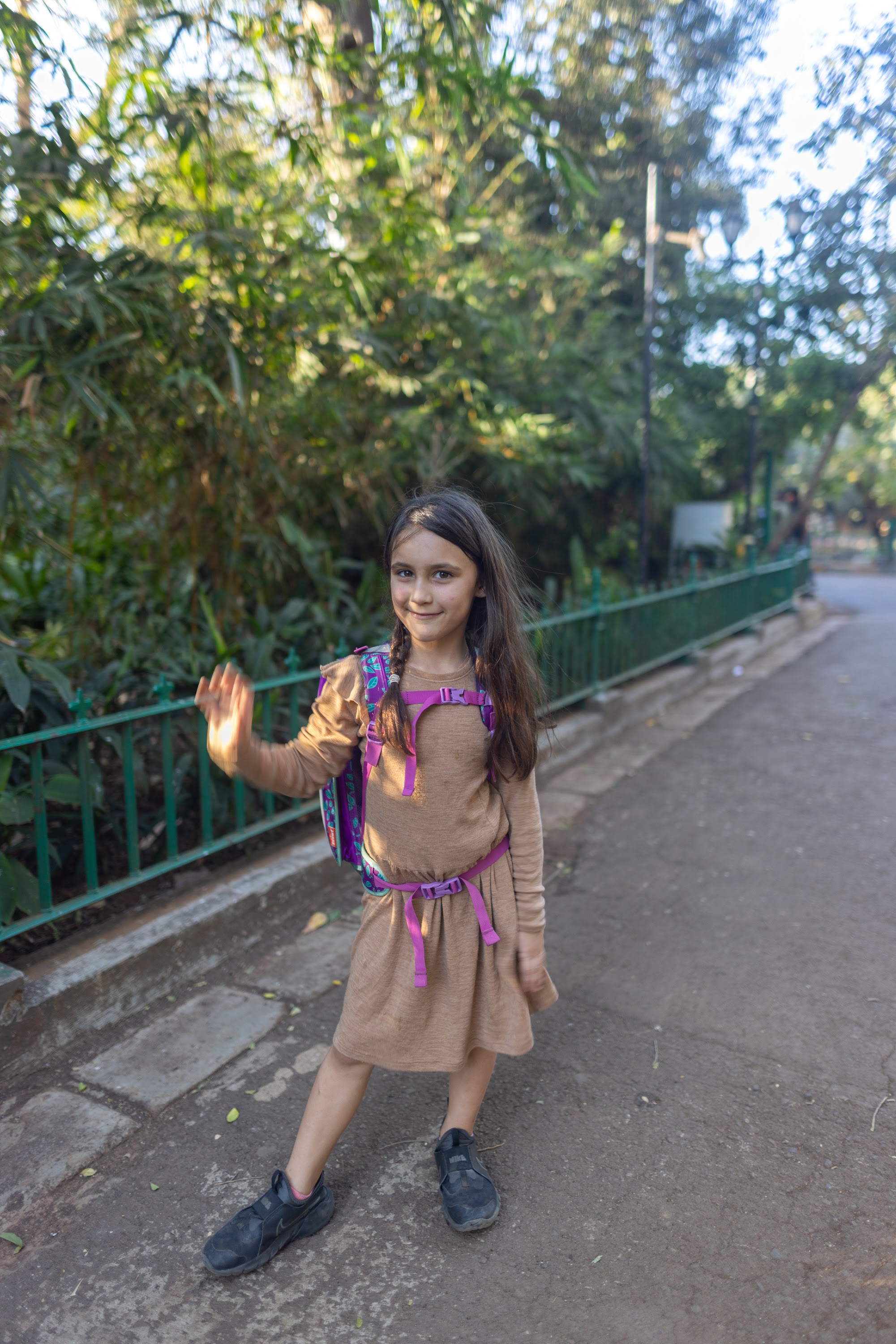Girl Waving on a Park Path