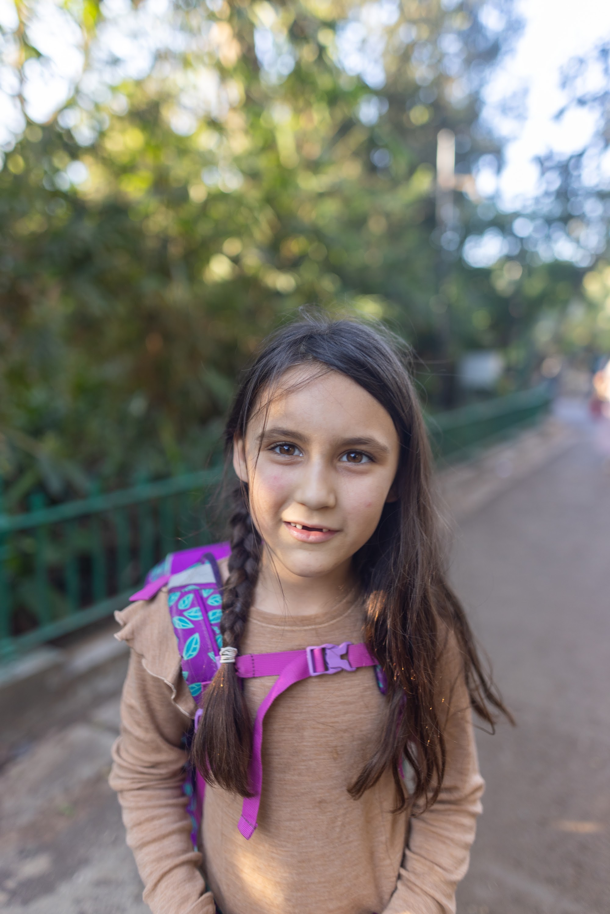 Girl with Braided Hair and Purple Backpack