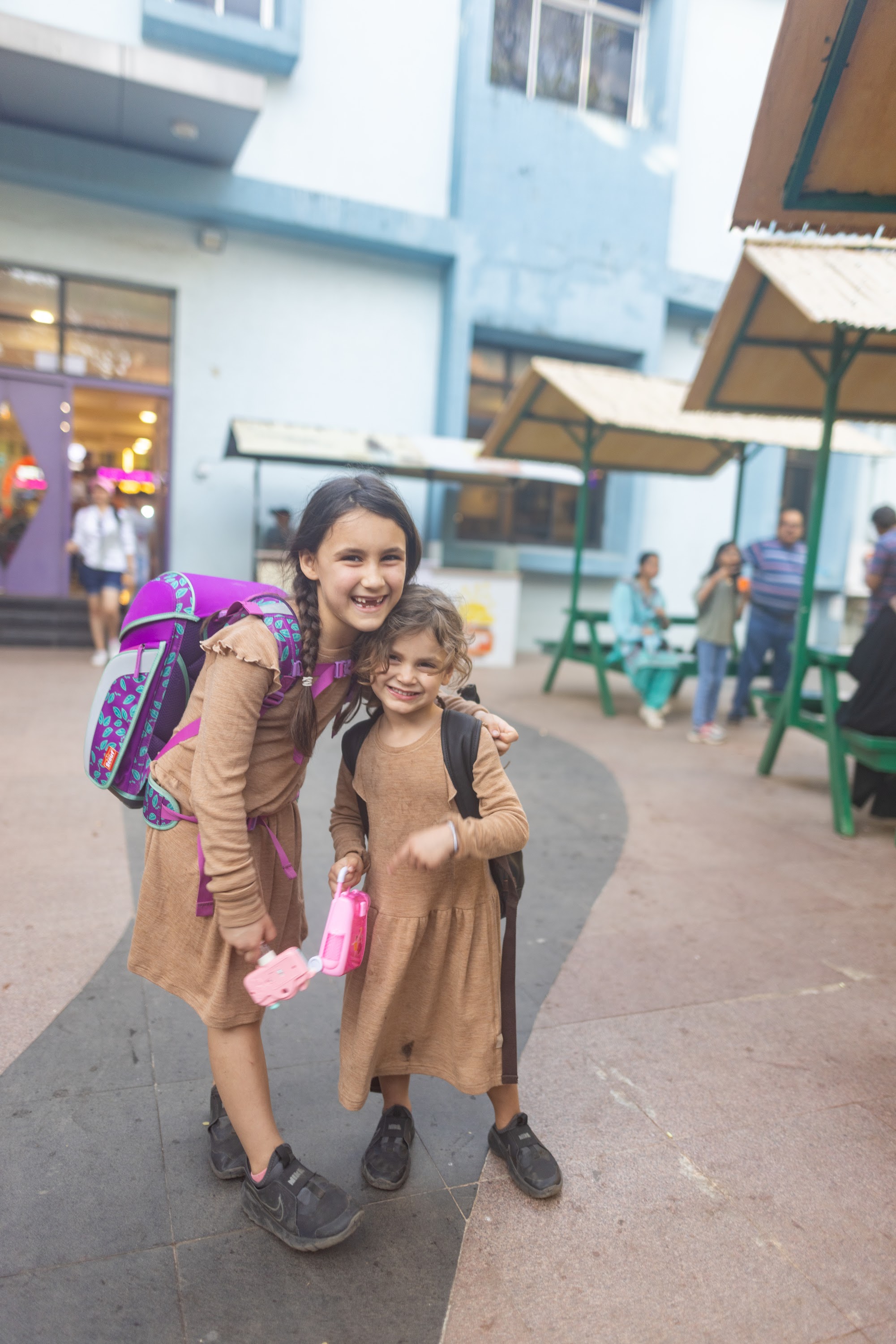 Two Girls Smiling with School Bags