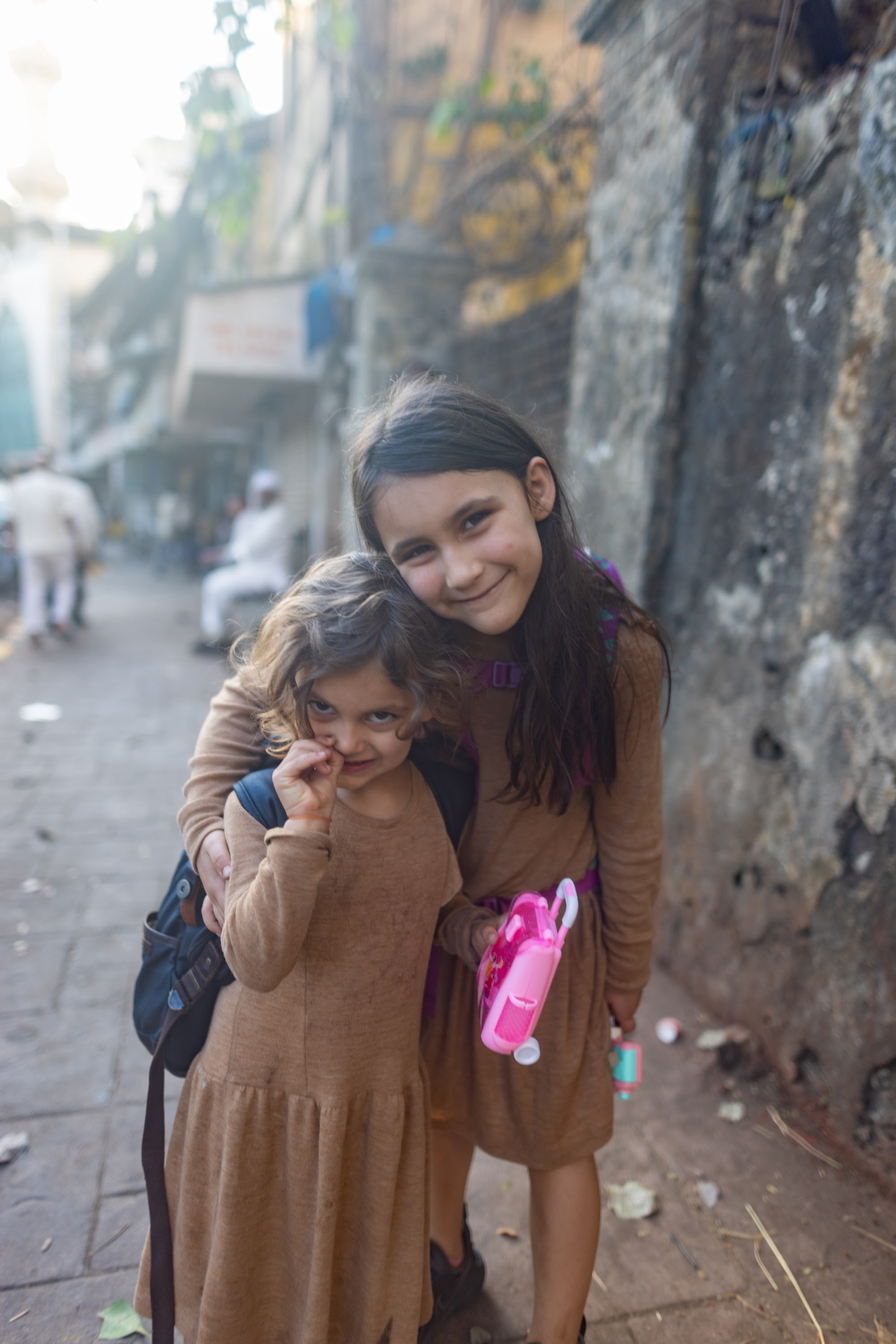 Two Girls Smiling on a Street