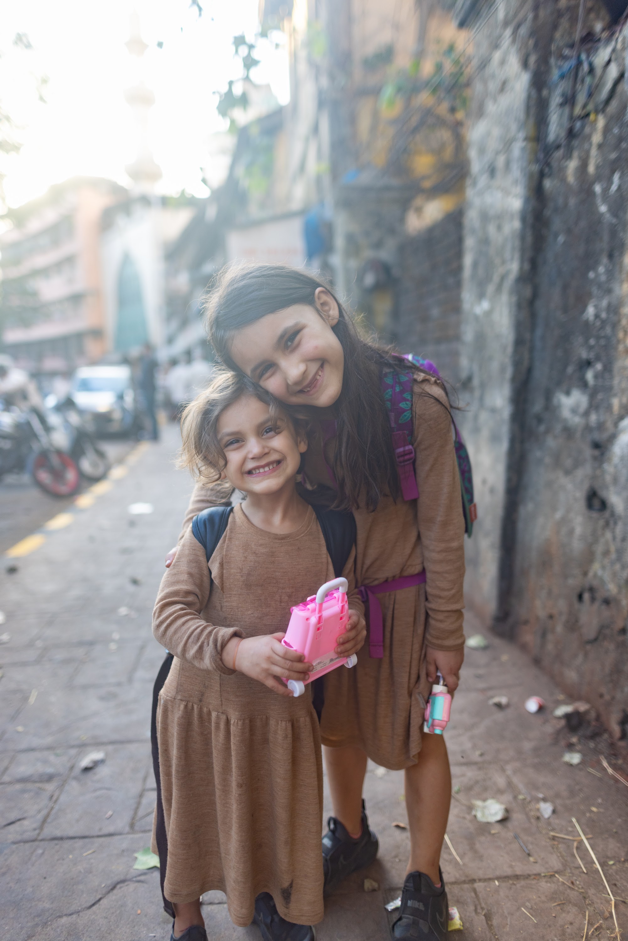Two Girls Hugging on a Street