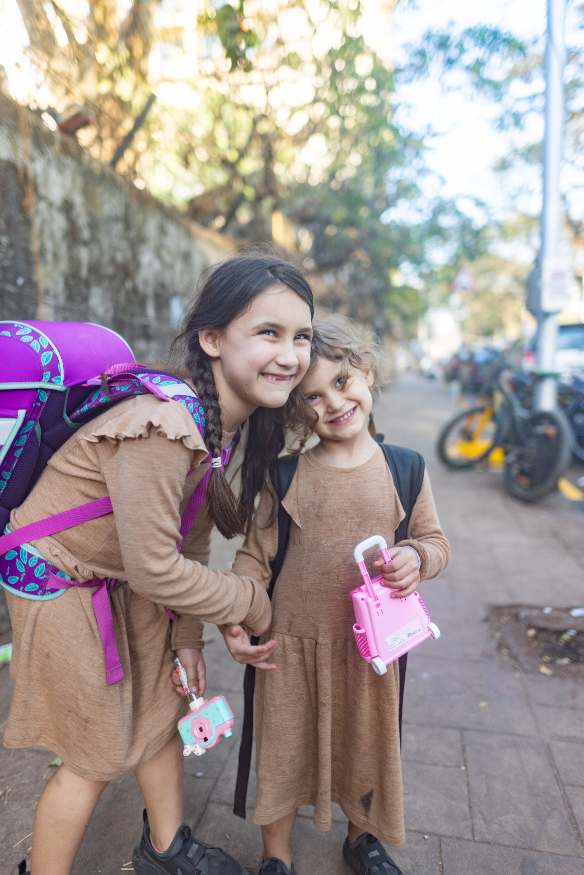 Two Girls Smiling on a City Street