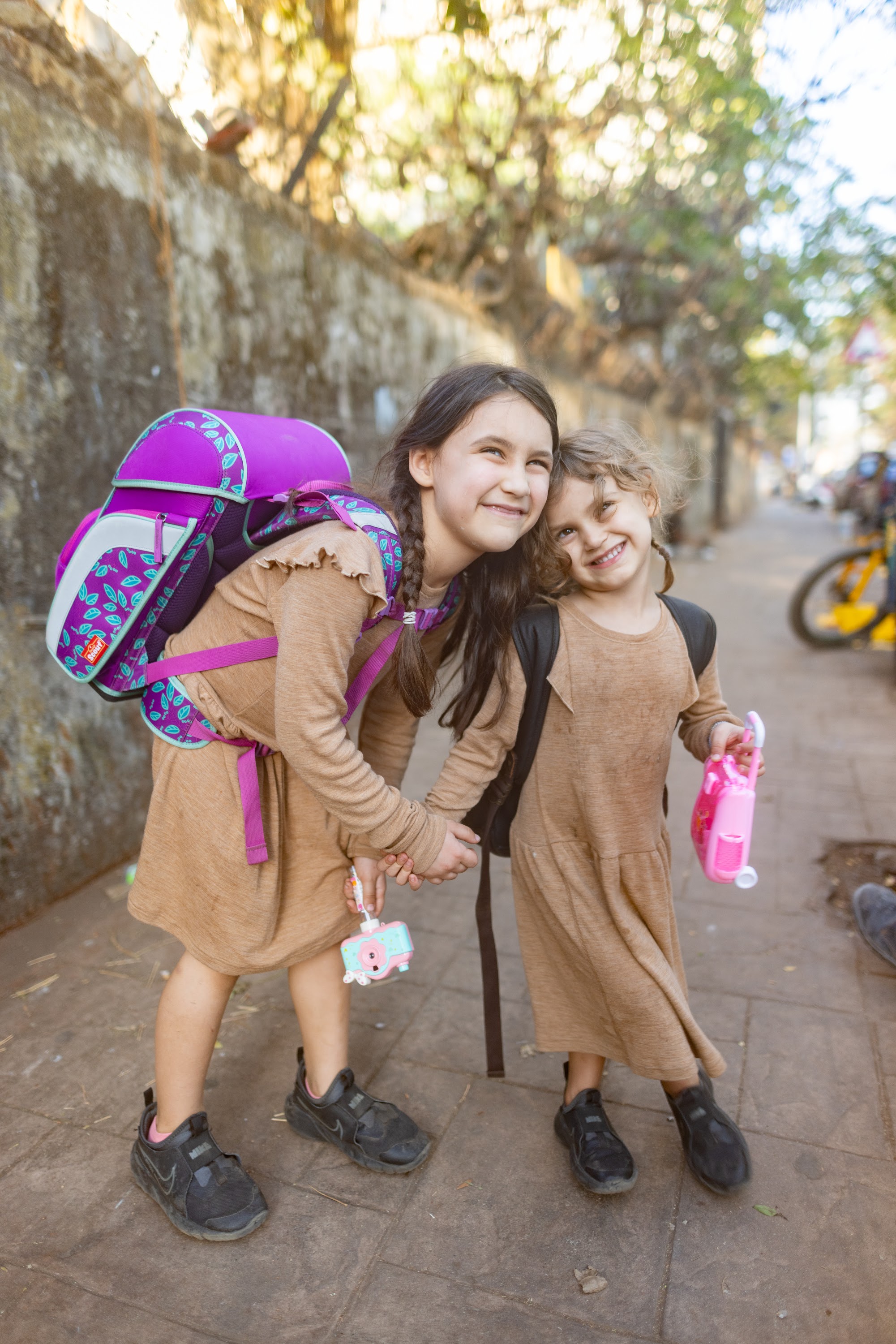 Two Girls Walking Together on a Sunlit Street