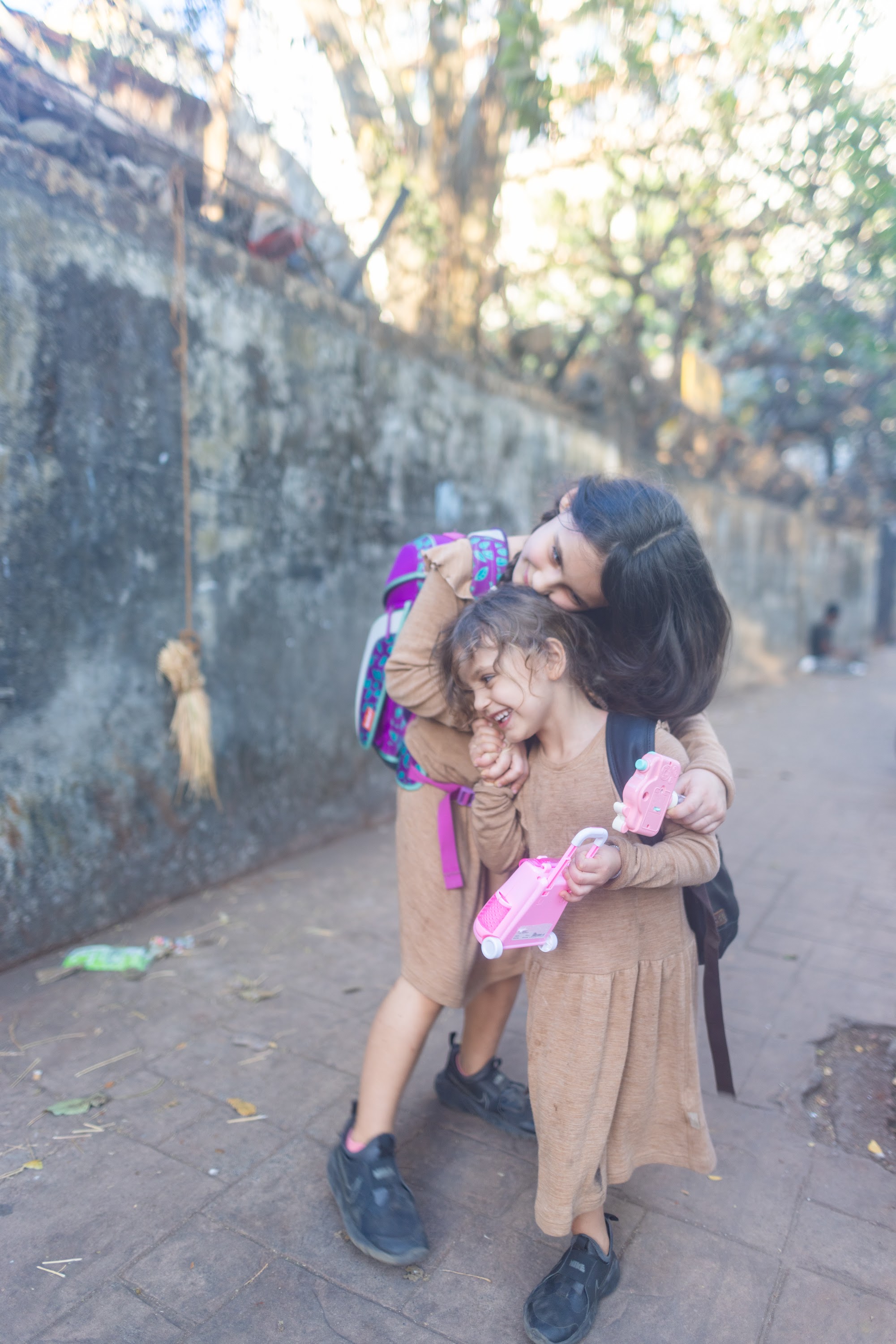Mother and Daughter Hugging on a Street