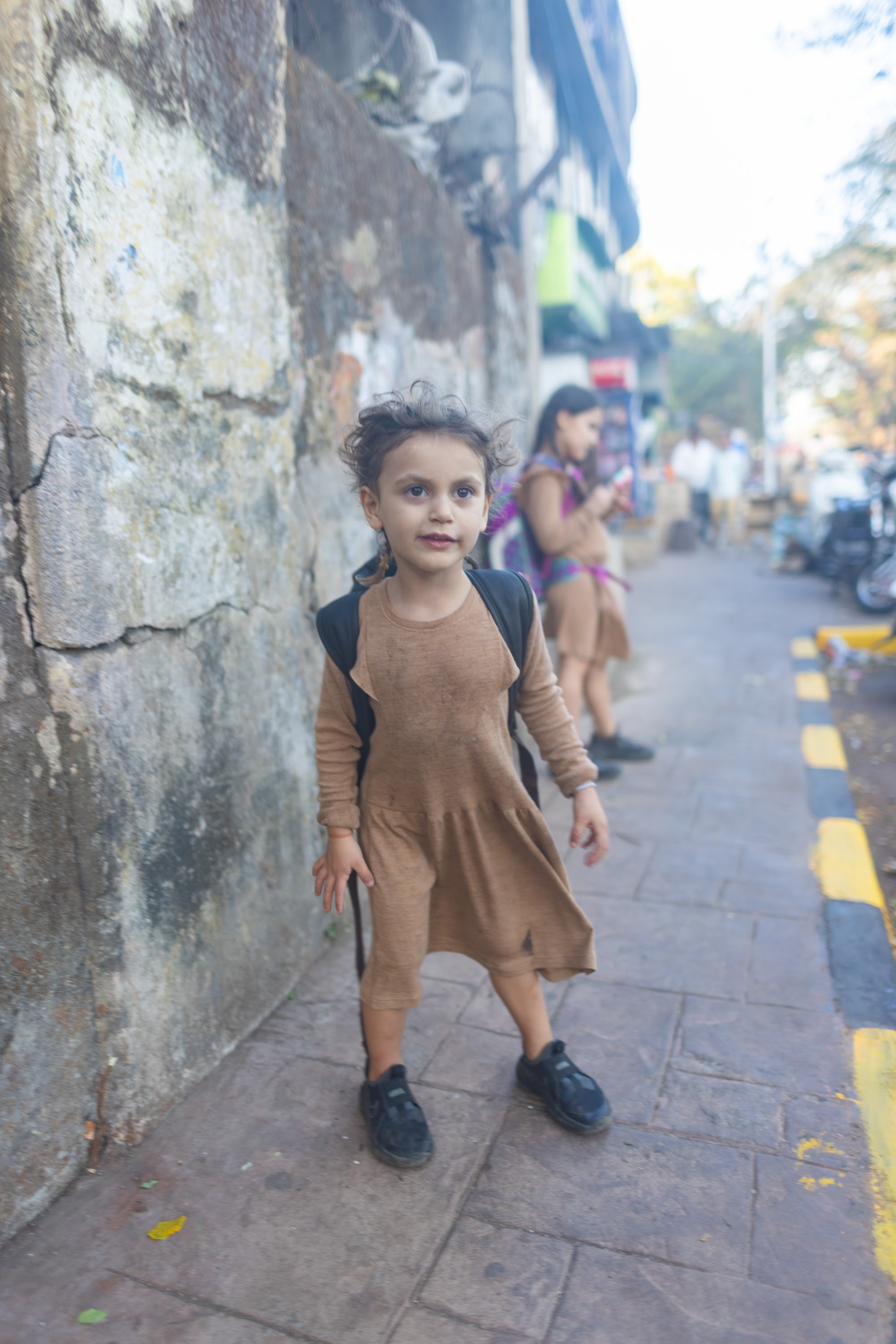 Young Girl Standing on Sidewalk
