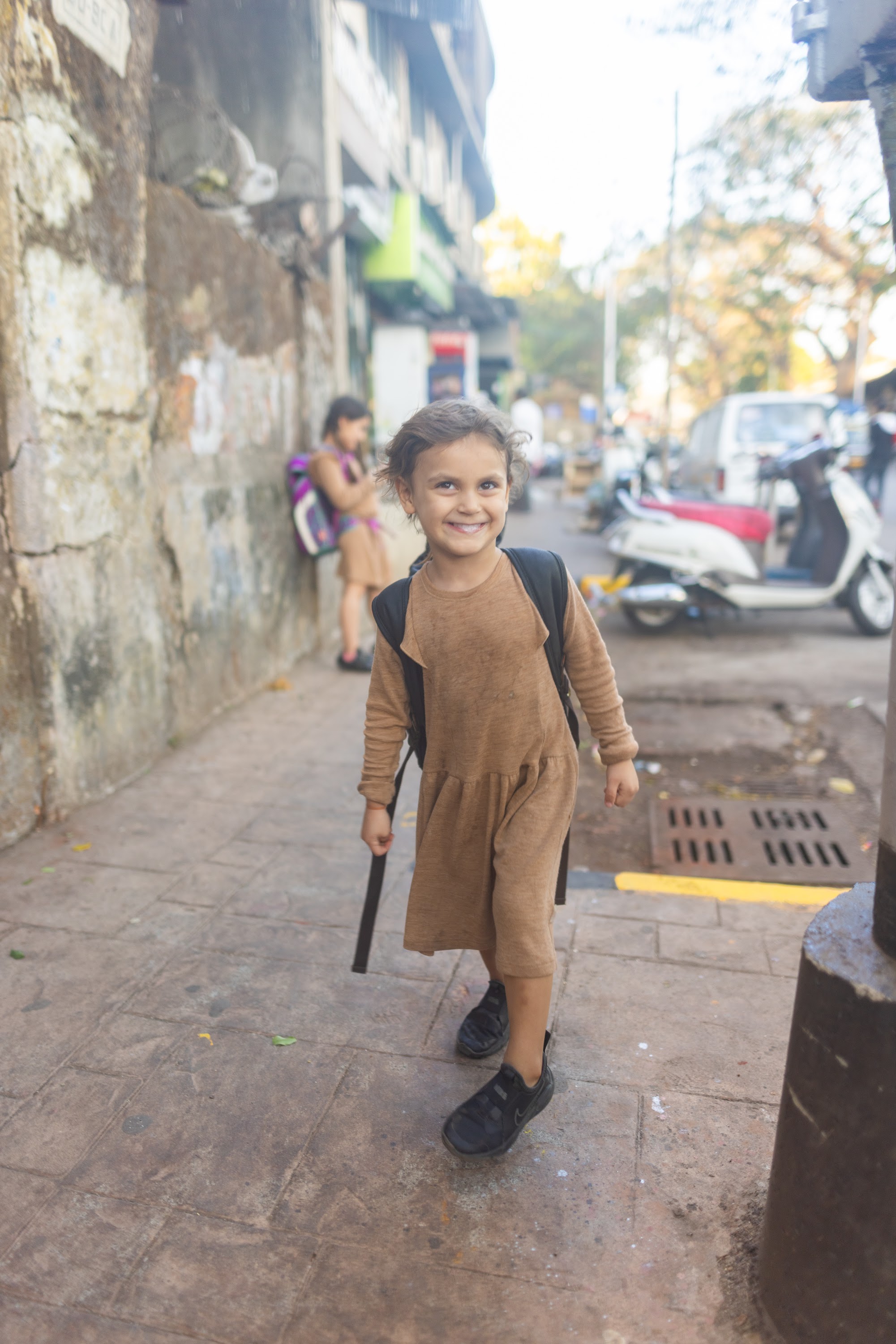 Smiling Girl Walking on Street with Backpack