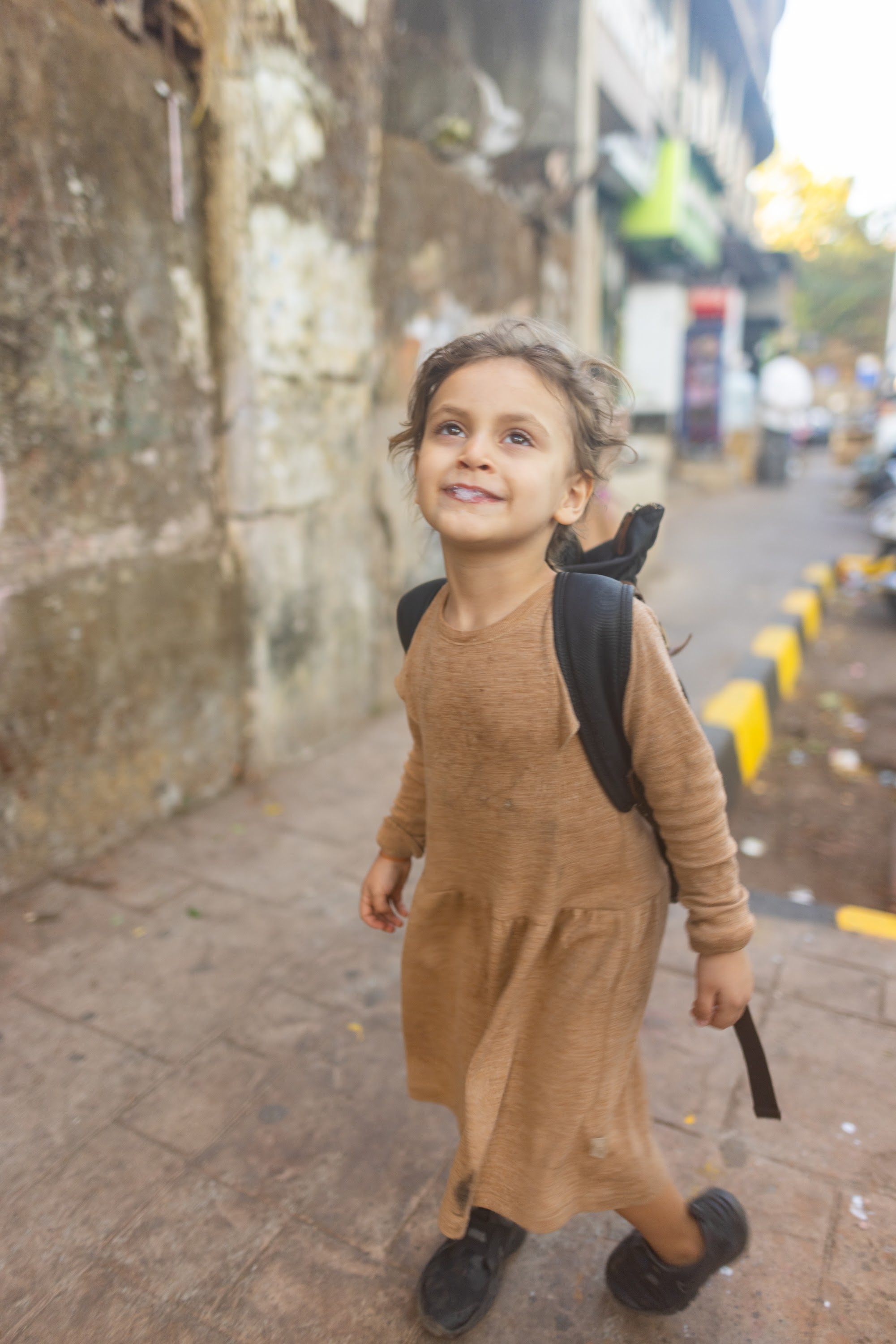 Smiling Child Walking Down Street