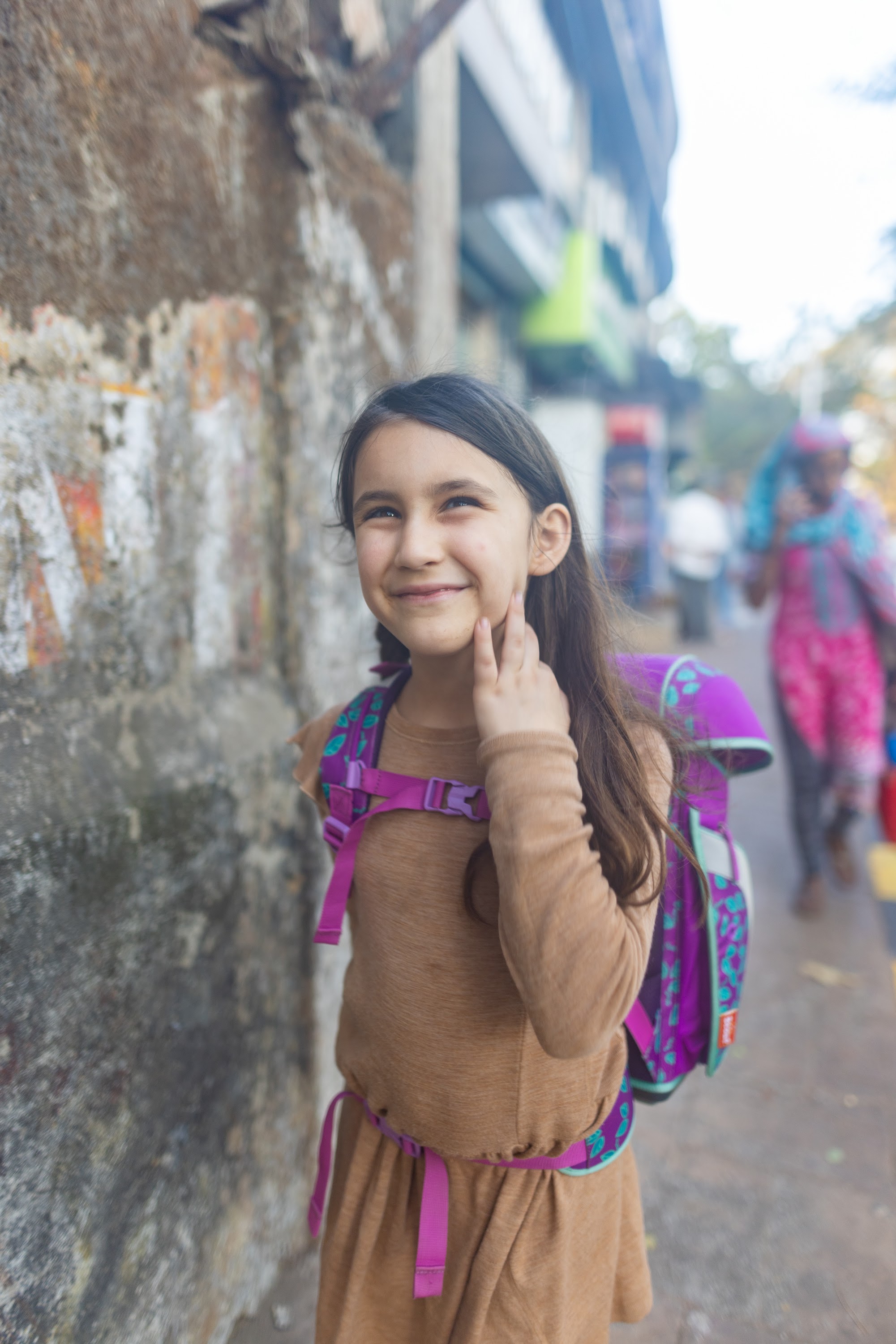 Smiling Girl with Backpack on Street